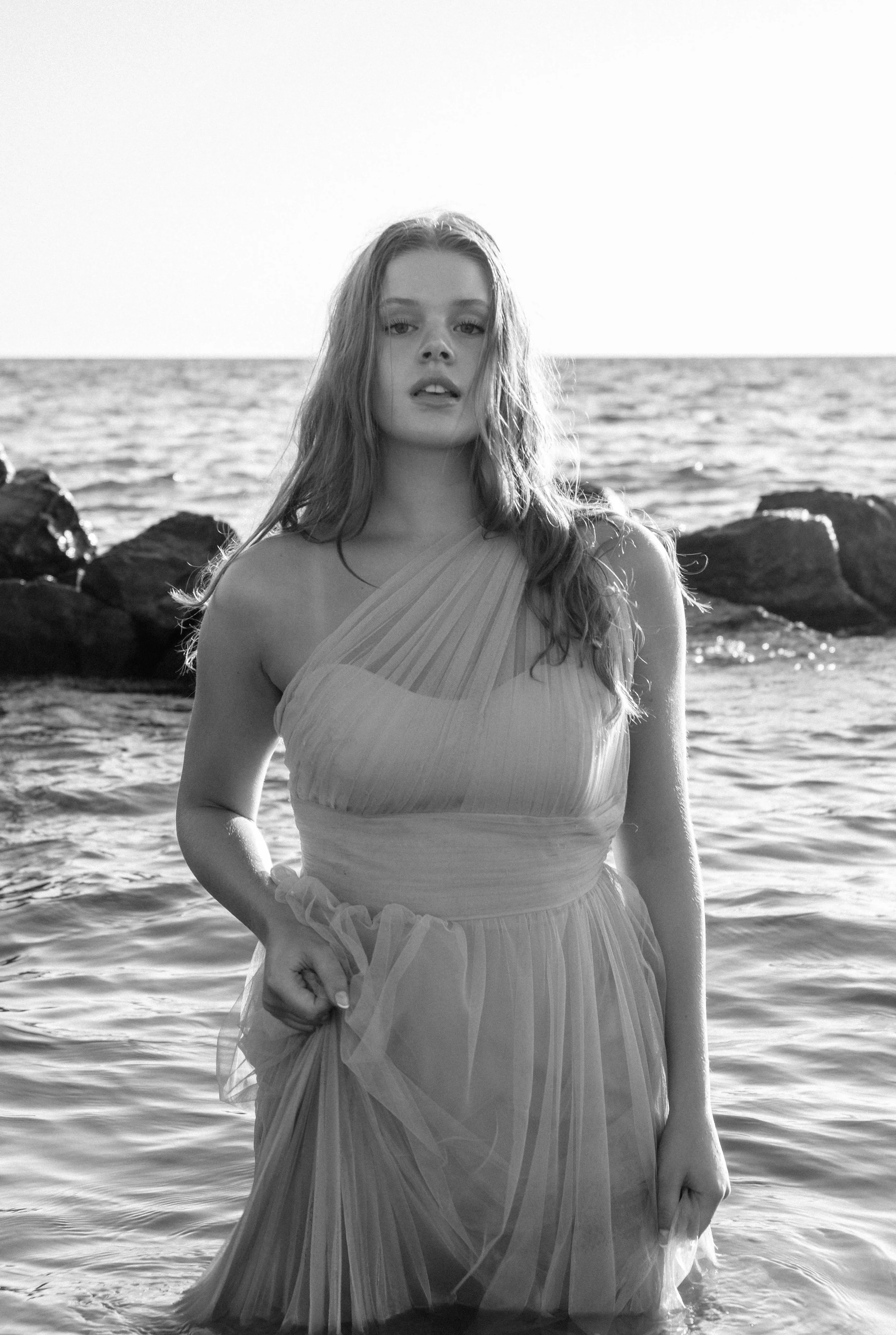 Black and white editorial portrait of a woman by the water — Grand Rapids photographer Olivia Feldman