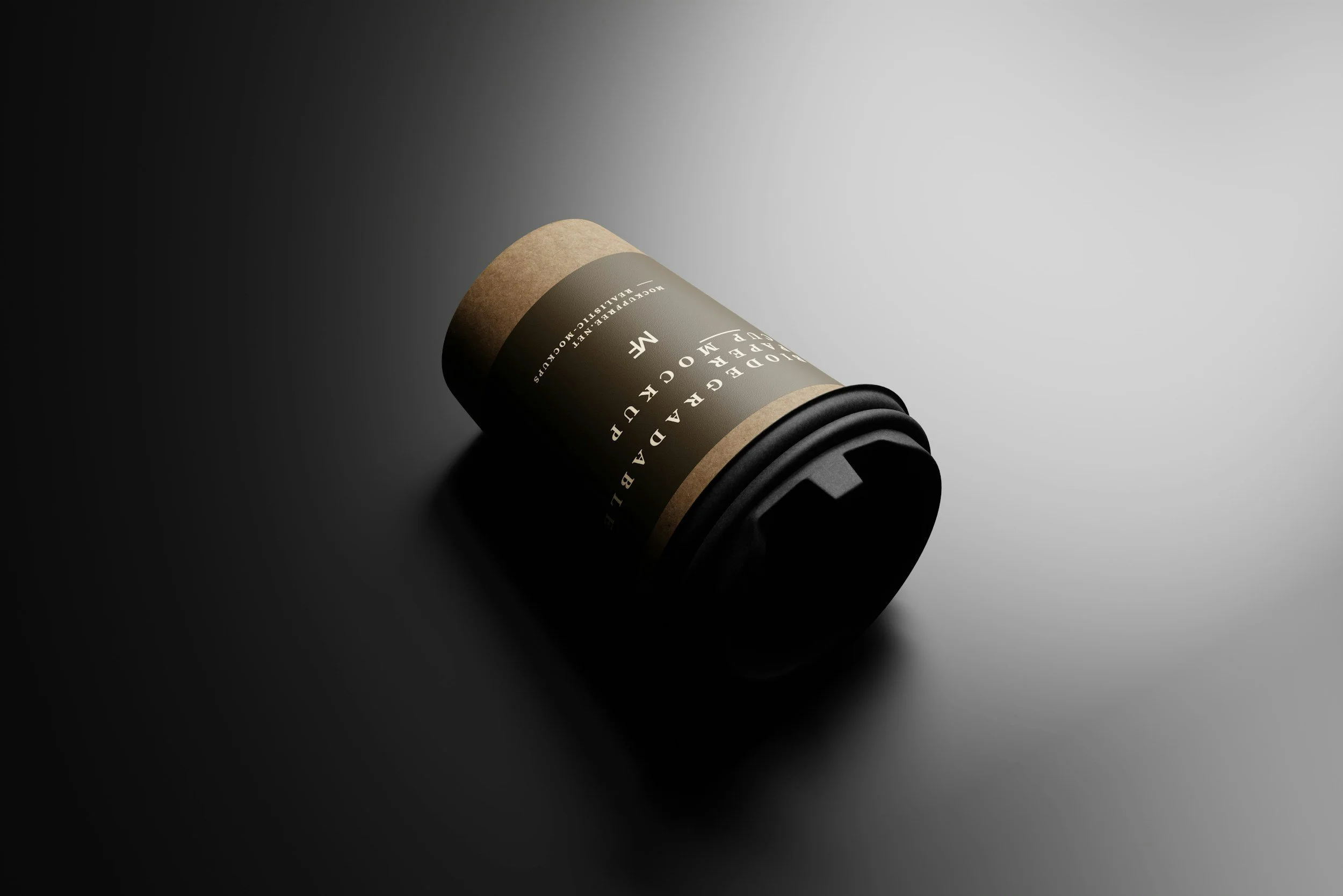 A black disposable coffee cup with a black lid and beige paper sleeve, lying on a gradient background from dark to light.