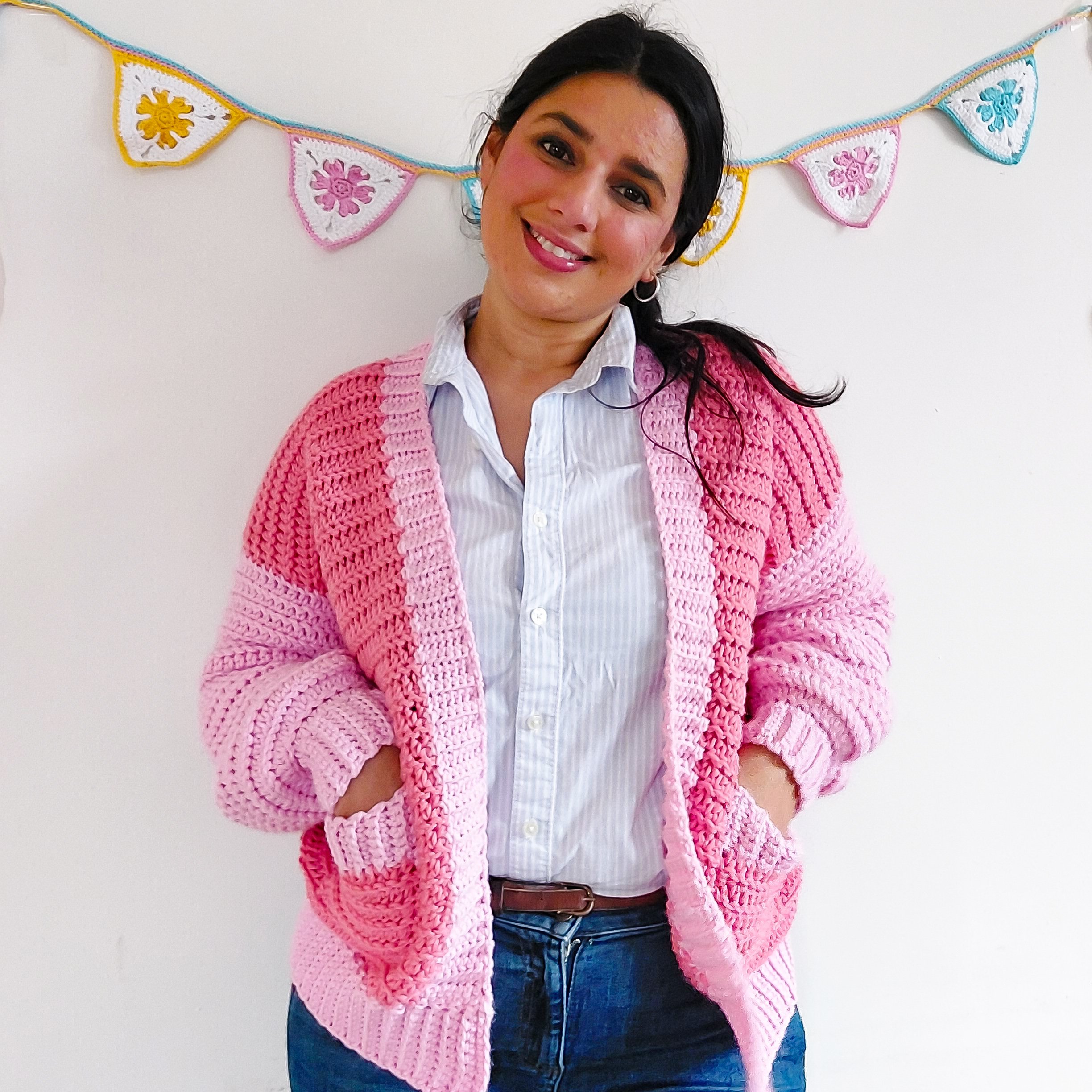 Young woman wearing a crochet chunky cardigan with pockets