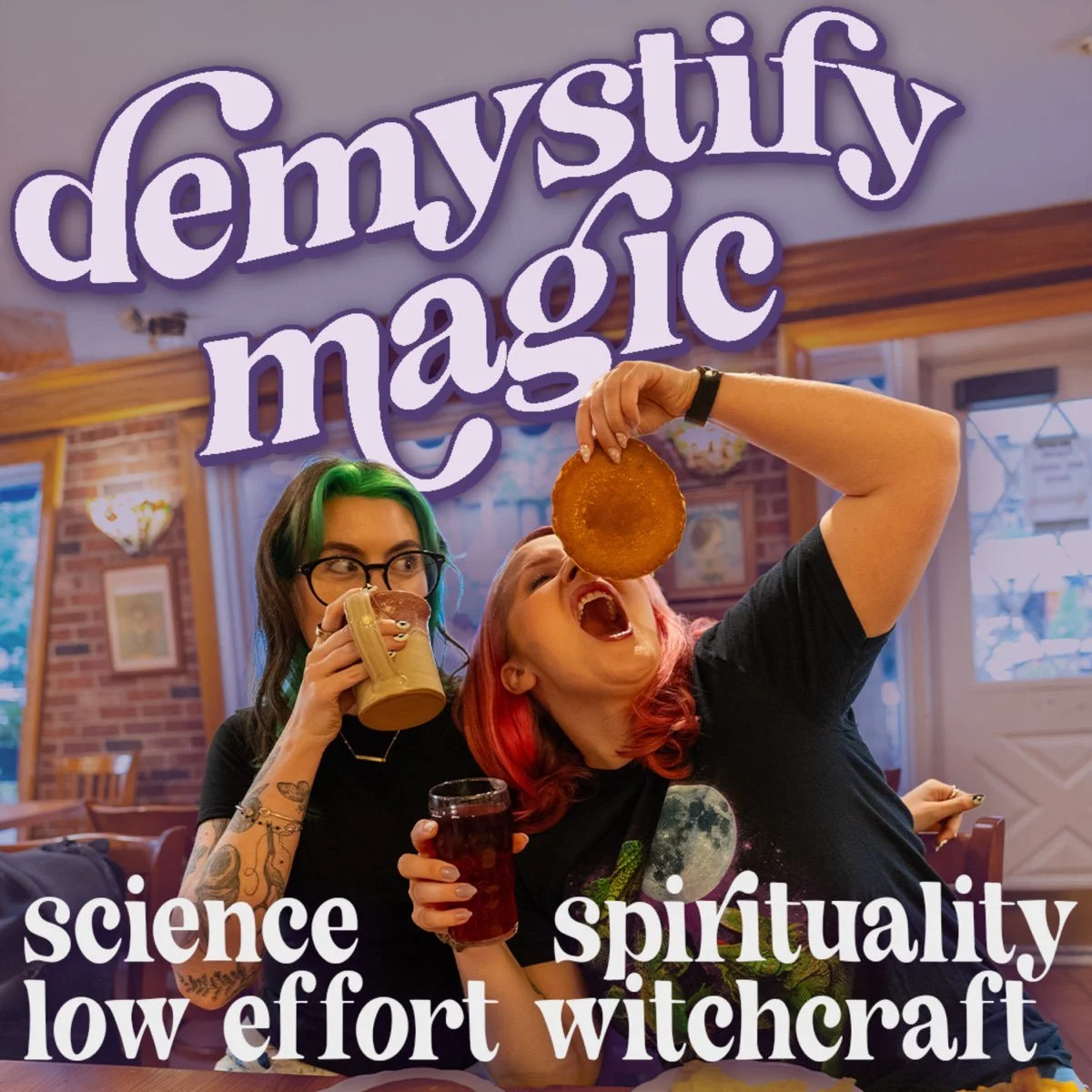 Two women with colorful hair enjoying food and drinks in a cozy indoor setting with a sign that reads 'demystyf y magic'. One woman is sipping from a mug, while the other is holding a large fried item above her mouth, with a drink in her other hand. The image has words like 'science,' 'spirituality,' 'low effort,' and 'witchcraft' overlayed at the bottom.