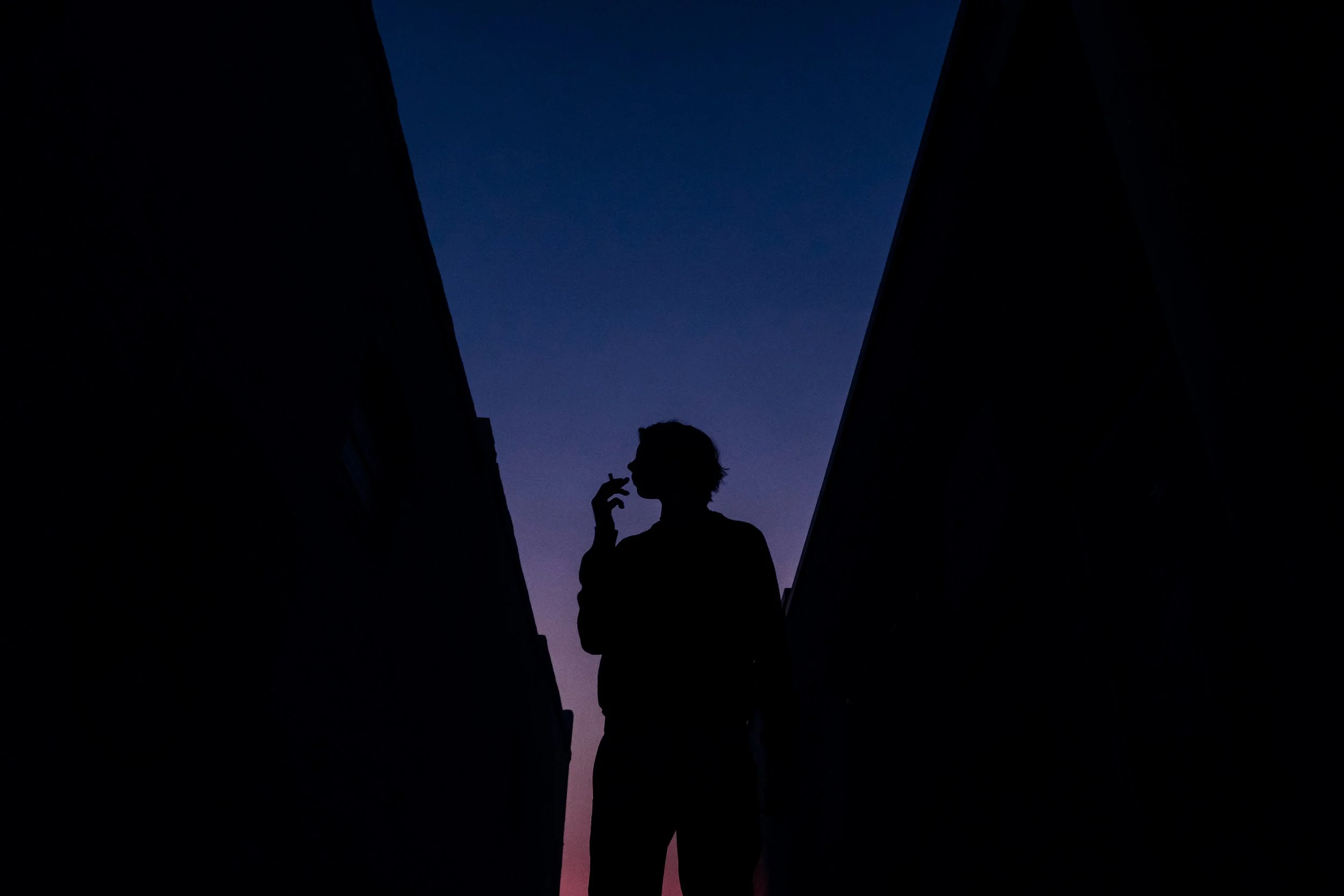 Photograph of brother smoking. From Dean Hinnant’s Blood series exploring siblinghood and family bonds