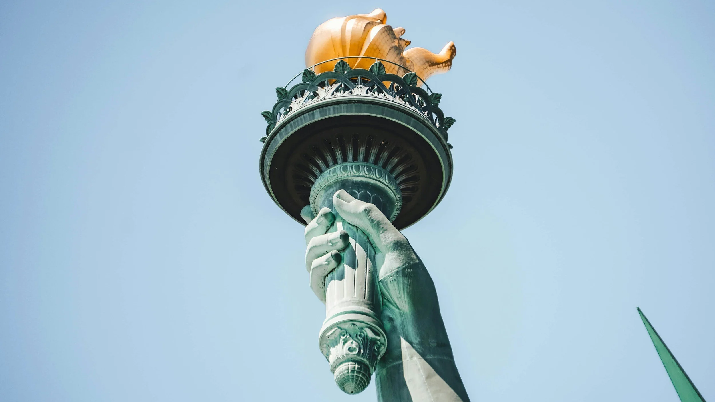 Close-up of the Statue of Liberty's torch, symbolizing freedom and hope, as Keystone State Notary provides notary and apostille services for immigration documents.
