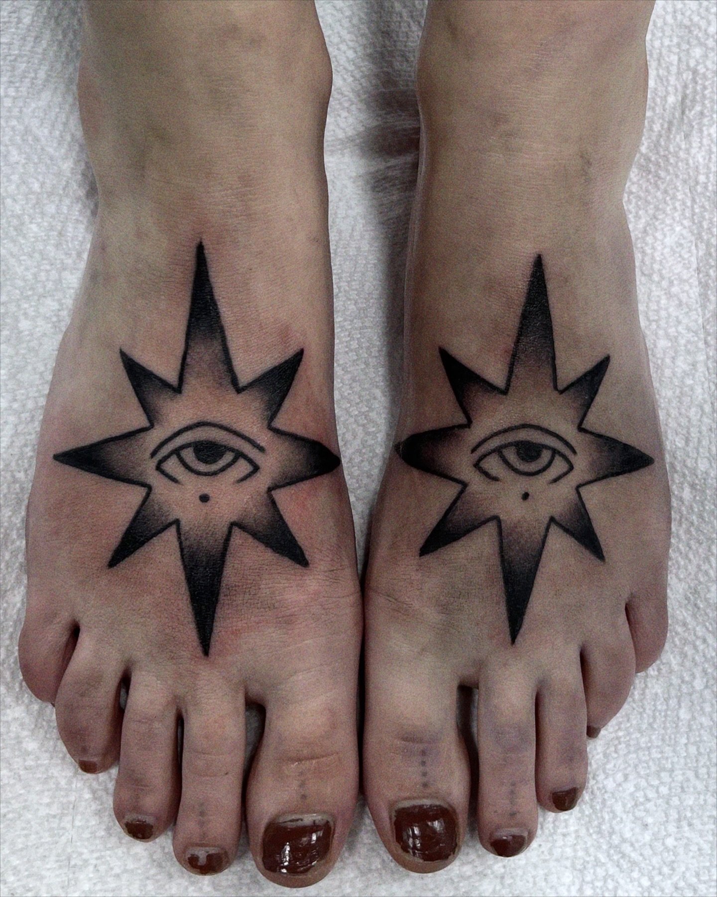 Matching starry eye tattoos from my flash book! on the top of the feet, ouch!