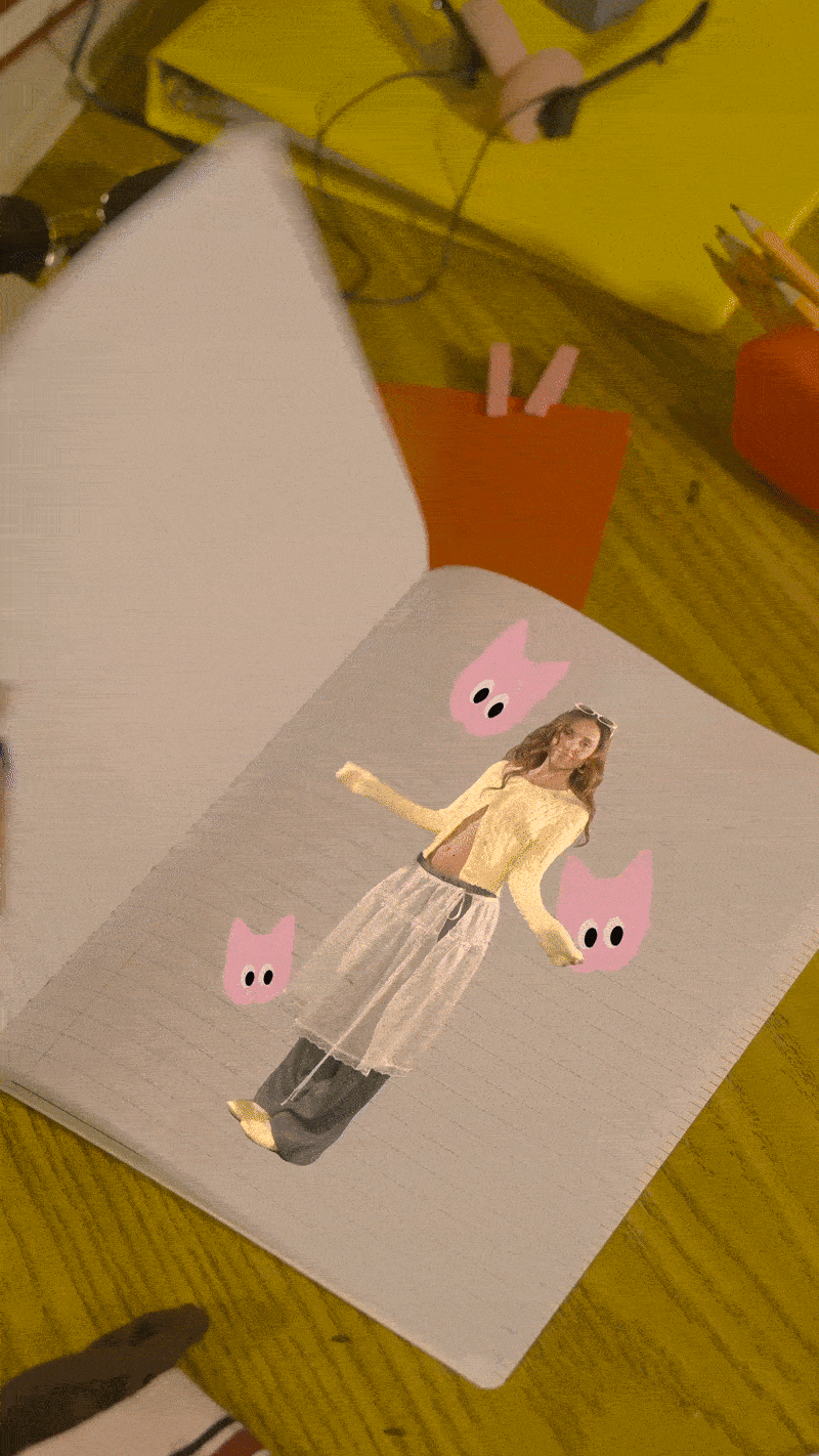 A photo of a magazine page on a wooden table featuring a woman in a yellow sweater and beige skirt, with pink cartoon pig faces surrounding her.