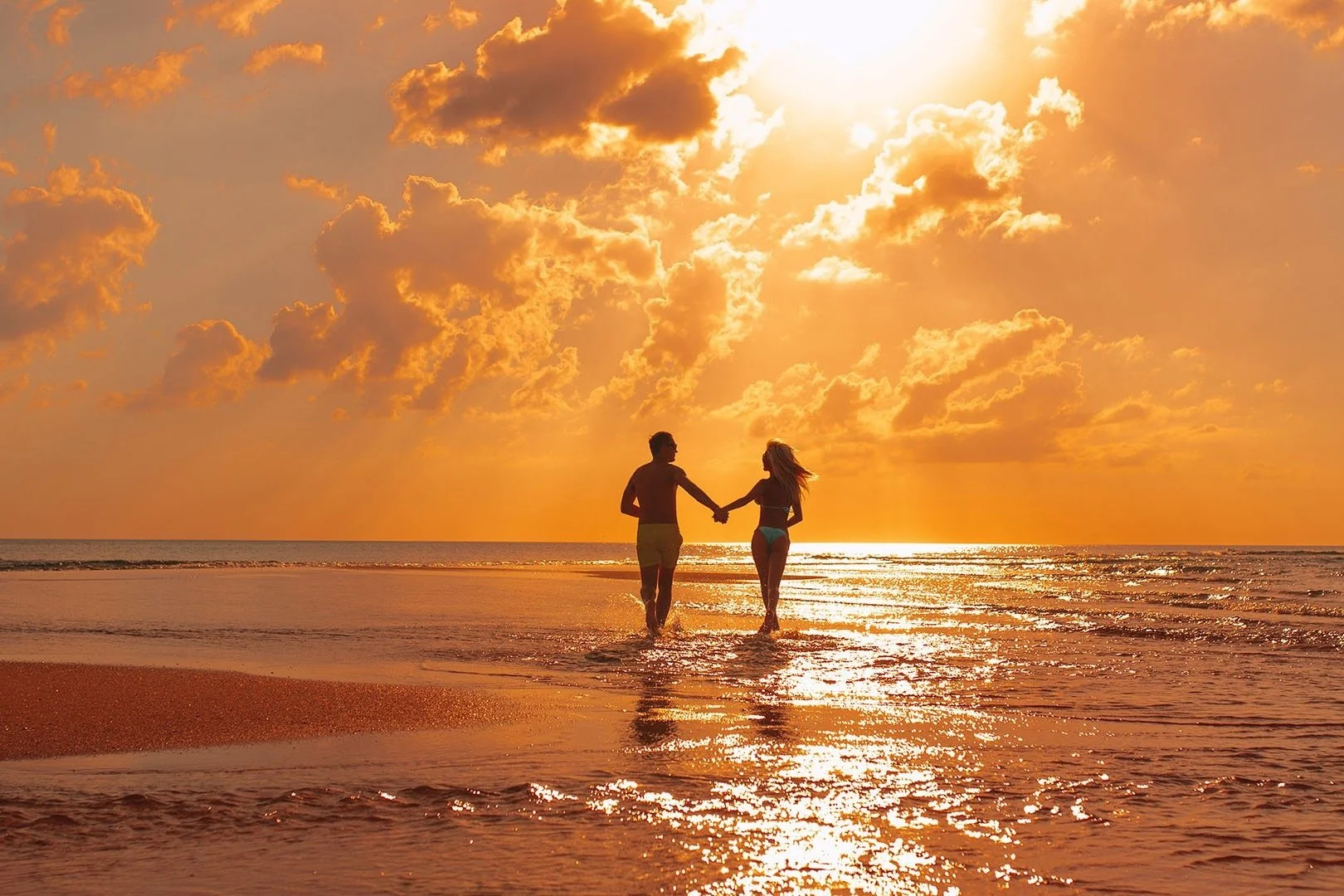 Couple-Walking-On-Beach-At-Sunset-1920-1080.jpg