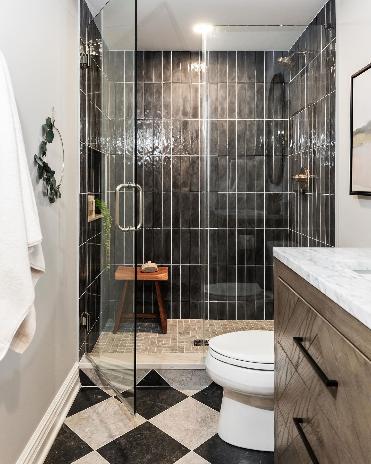 This basement bathroom was basic and blah, so it was totally reimagined! Originally there was just a pedestal sink and toilet, but luckily there was space available behind the back wall to open up and create a spa-like shower. Swipe over for the befo