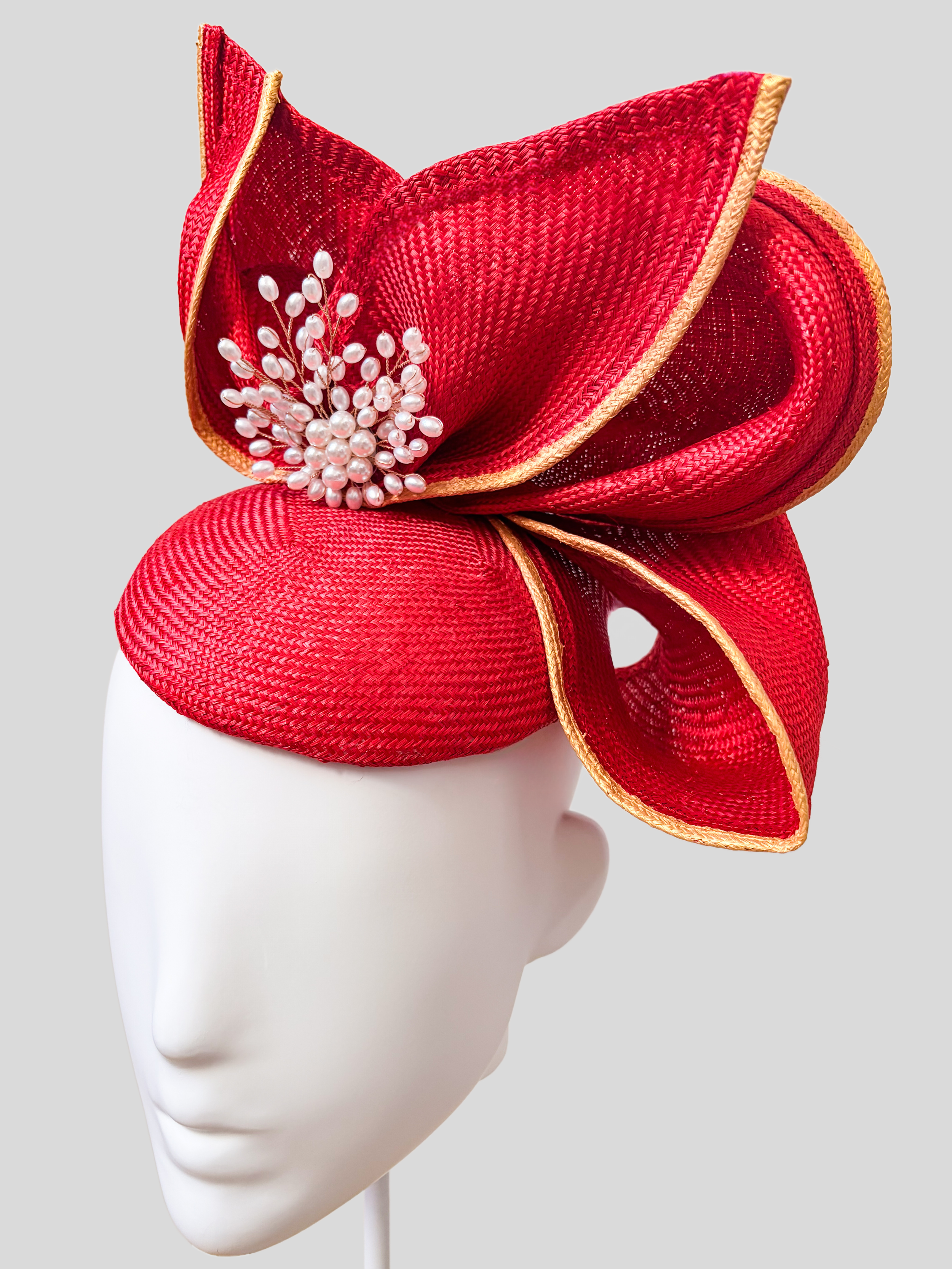 Close-up of Aria Ruby metallic Parisisal straw, gold edging and pearl and crystal detailing.