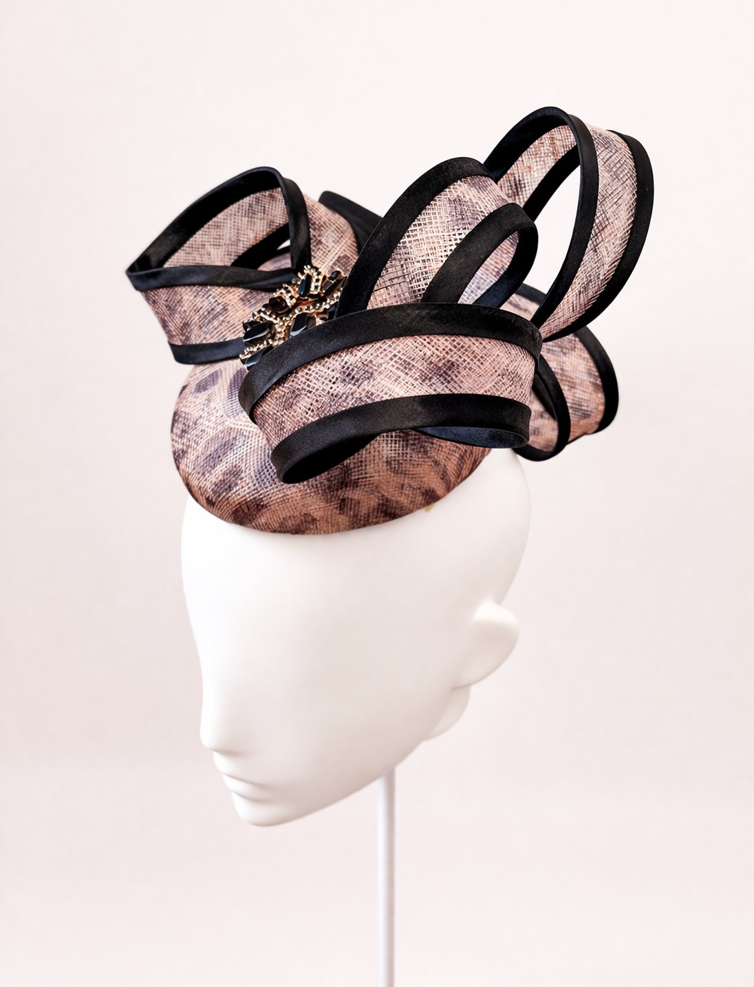 Elegant millinery headpiece on mannequin.JPEG