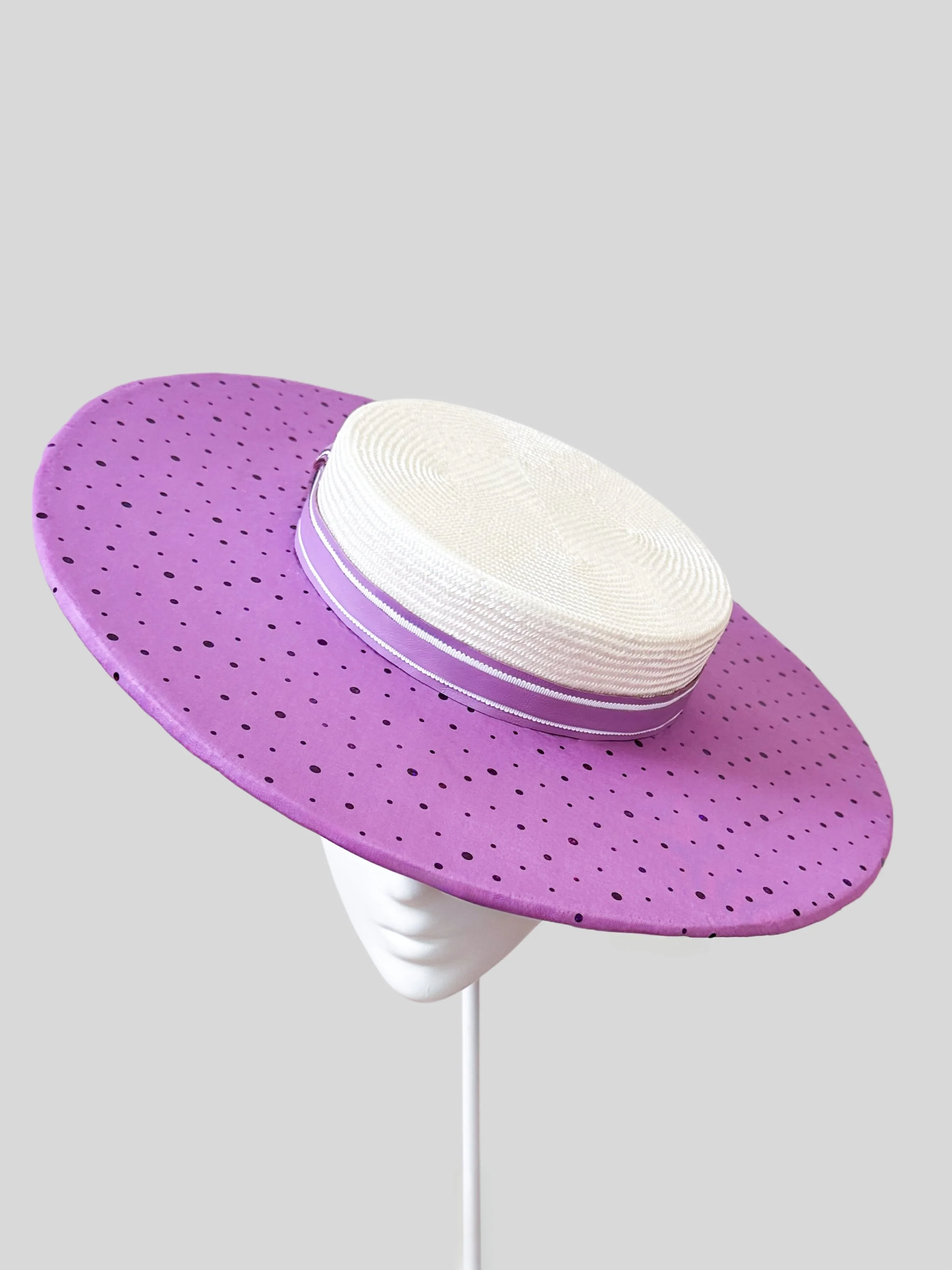 Front view of the classic boater hat. This two-toned headpiece features a luxurious ivory brim and a fun purple brim, handmade in Melbourne.