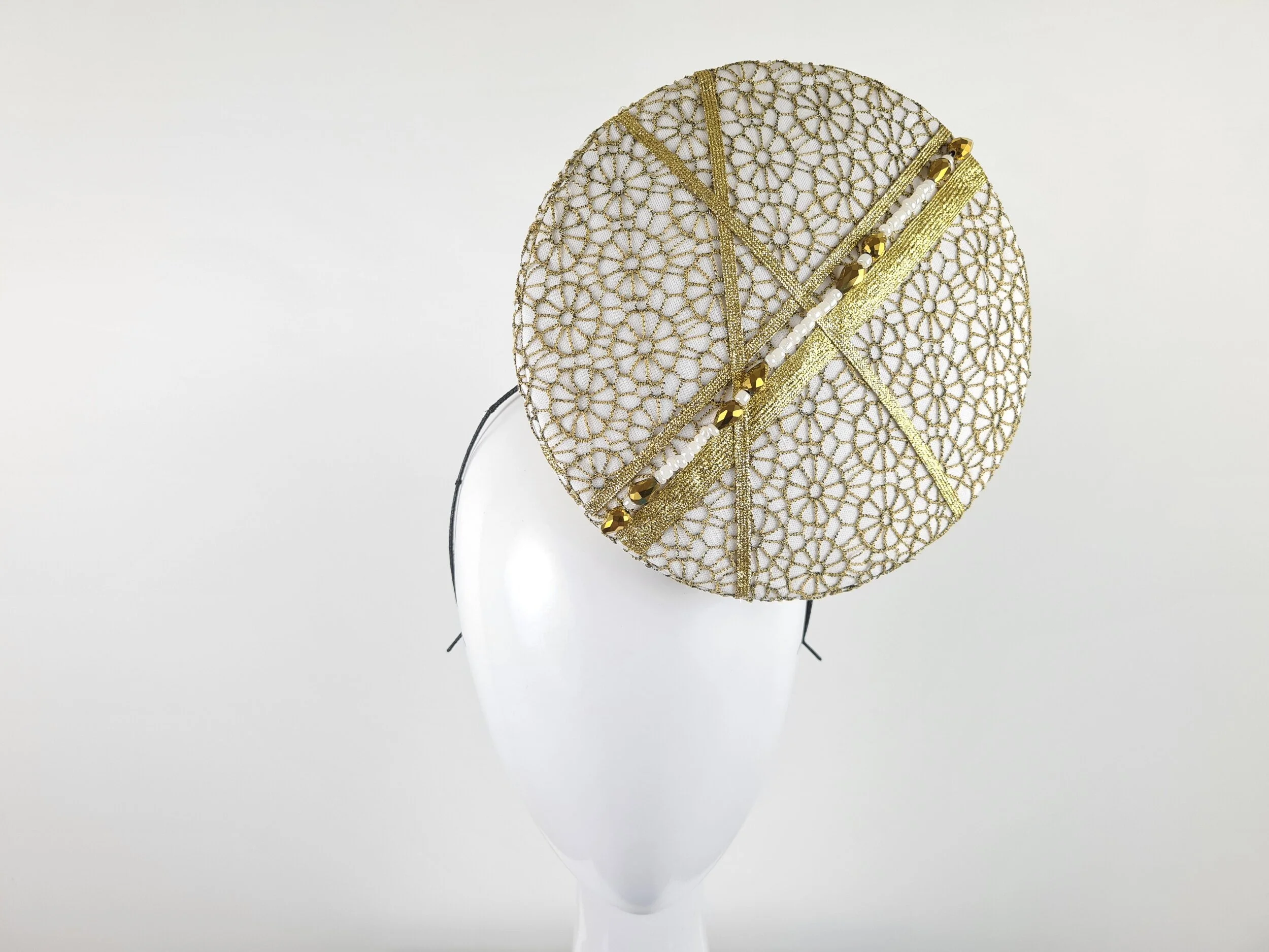 Front view of the white and gold lace percher hat, displaying its stunning appearance and unique percher style.