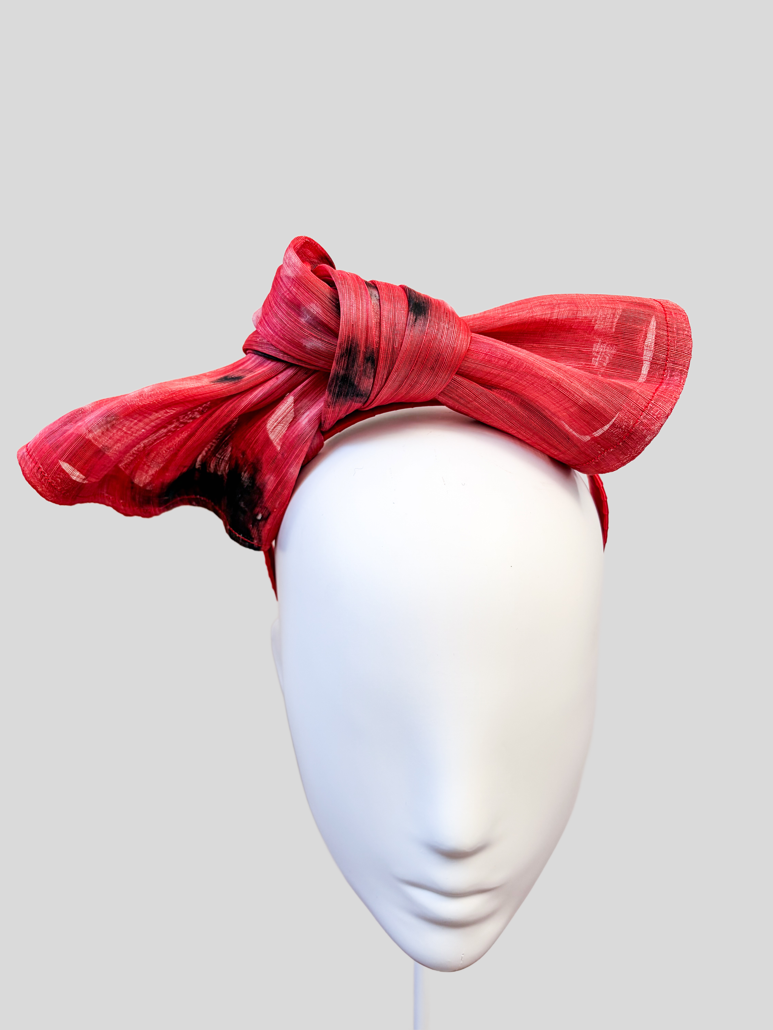 red-bow-headband-sinamay-knot-close-up.jpg.png
