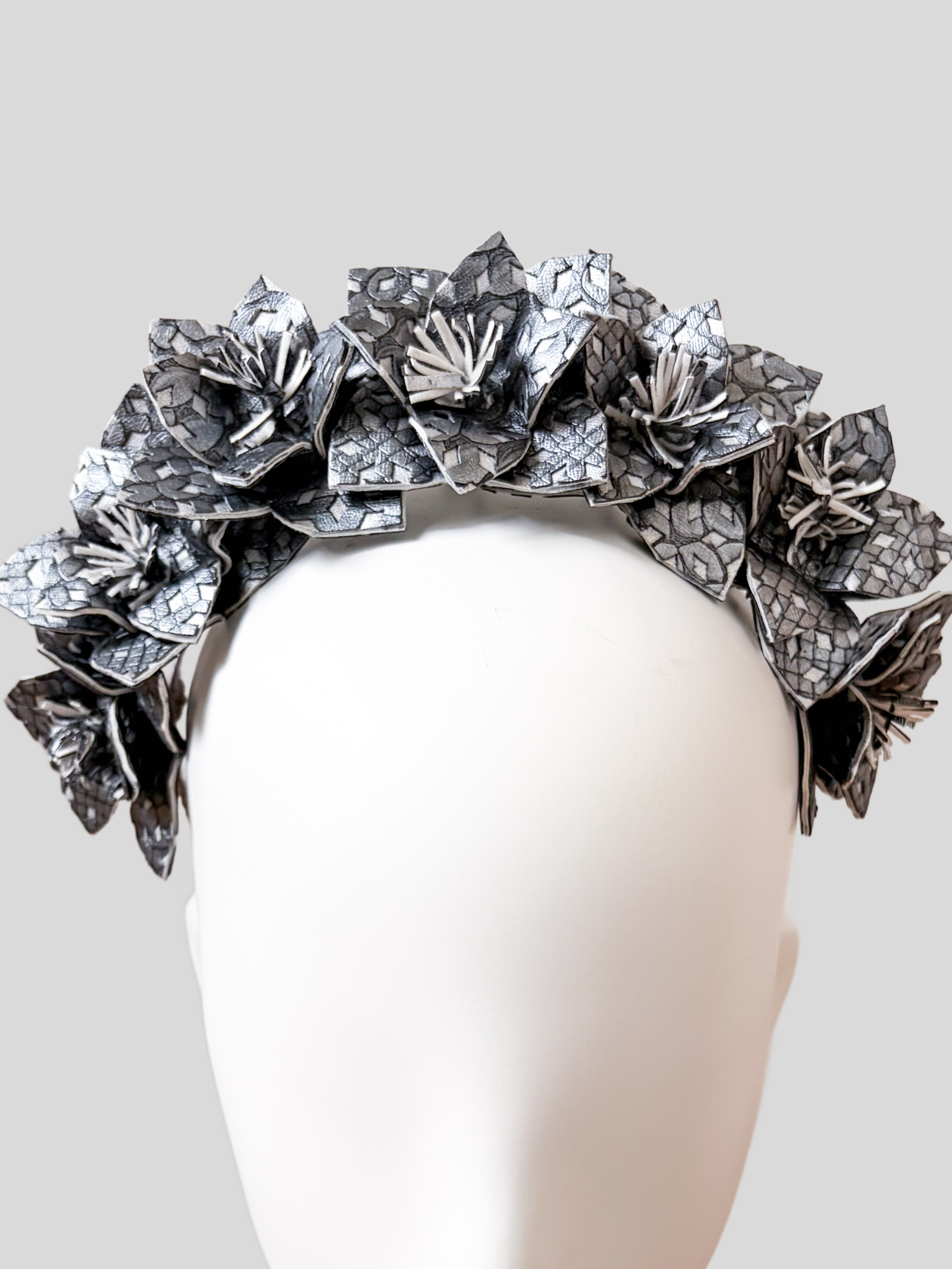 silver-textured-faux-leather-floral-headband-close-up.jpg.png