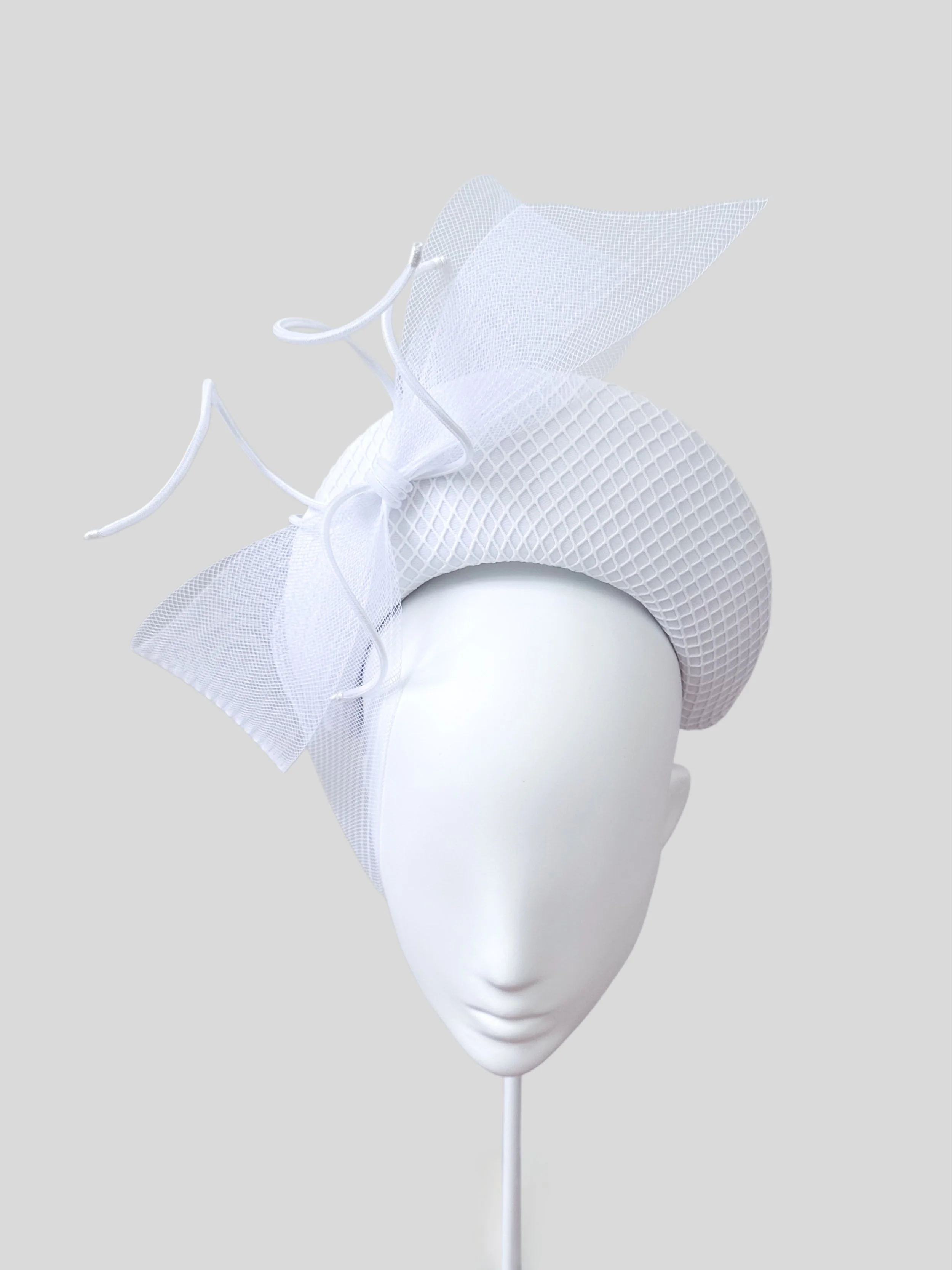Front view of the "Sognante Bianco" white halo headband. Showcasing its ethereal style and the arrangement of the lace netting, crinoline bow, and twisted tubing. One size fits most.