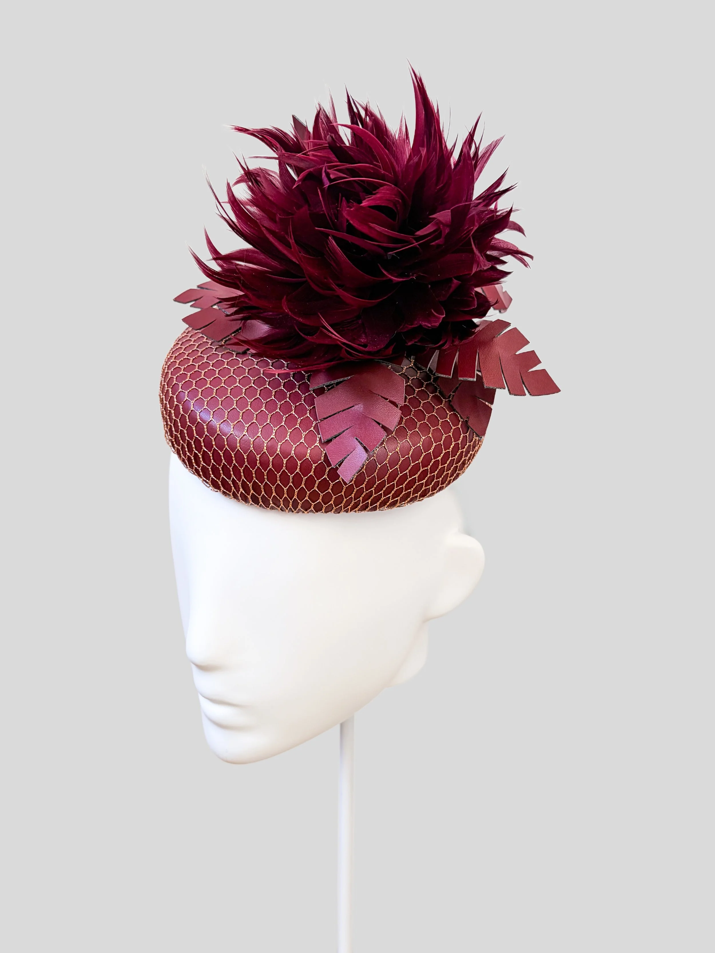 Right: Nocturne Amethyst purple feather cocktail hat shown from the right side.
