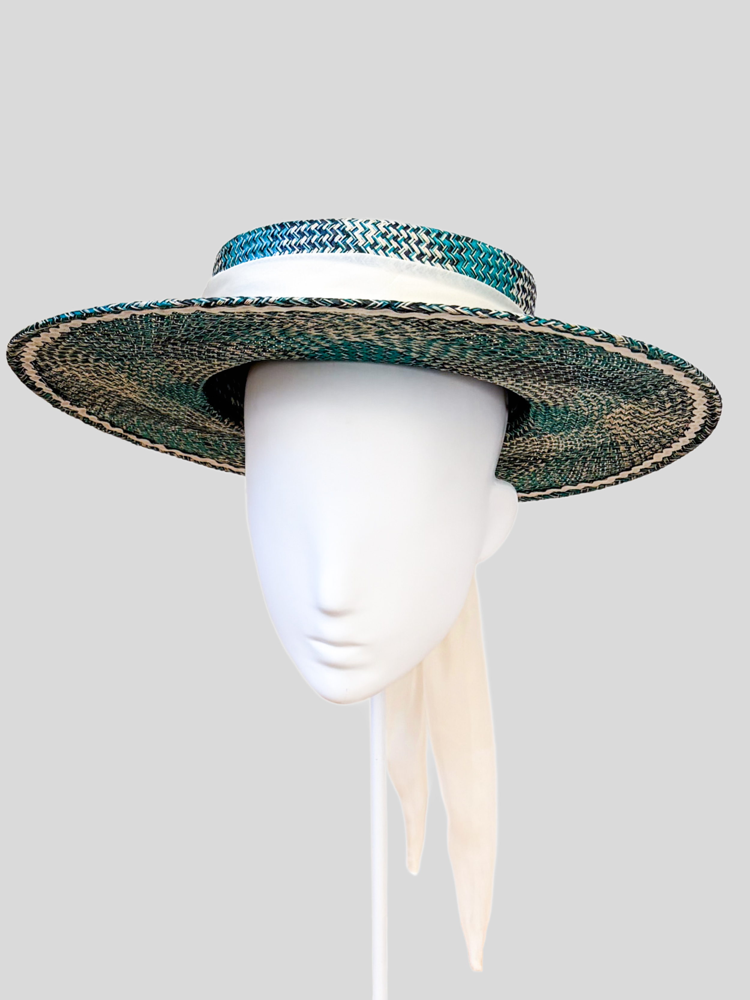 Solara Azure woven boater hat in navy, turquoise and off-white with a soft apricot chiffon tie.