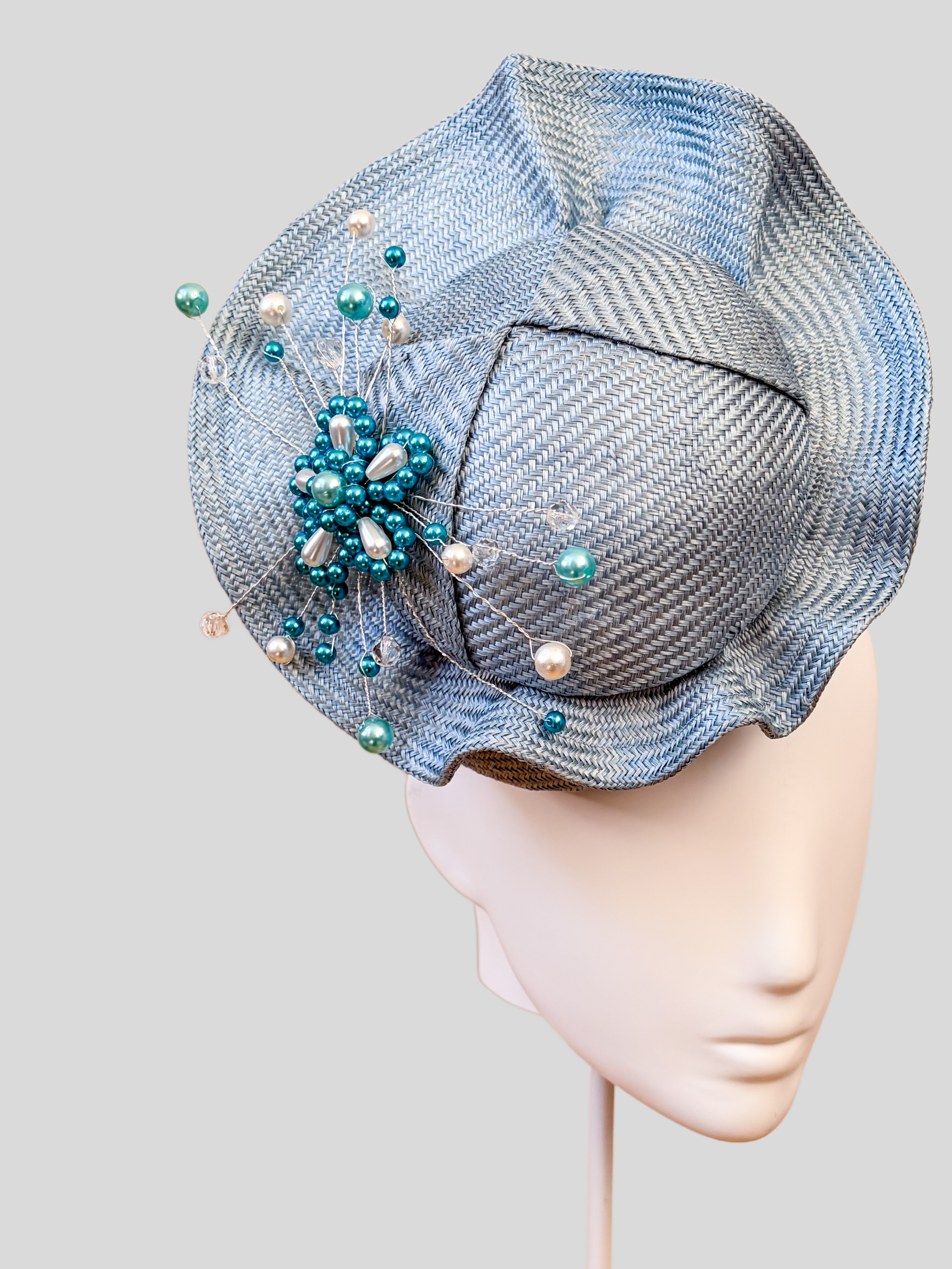Close-up: Close-up of the hand-beaded sky-blue embellishment featuring tonal beads, pearls and crystal-style details.