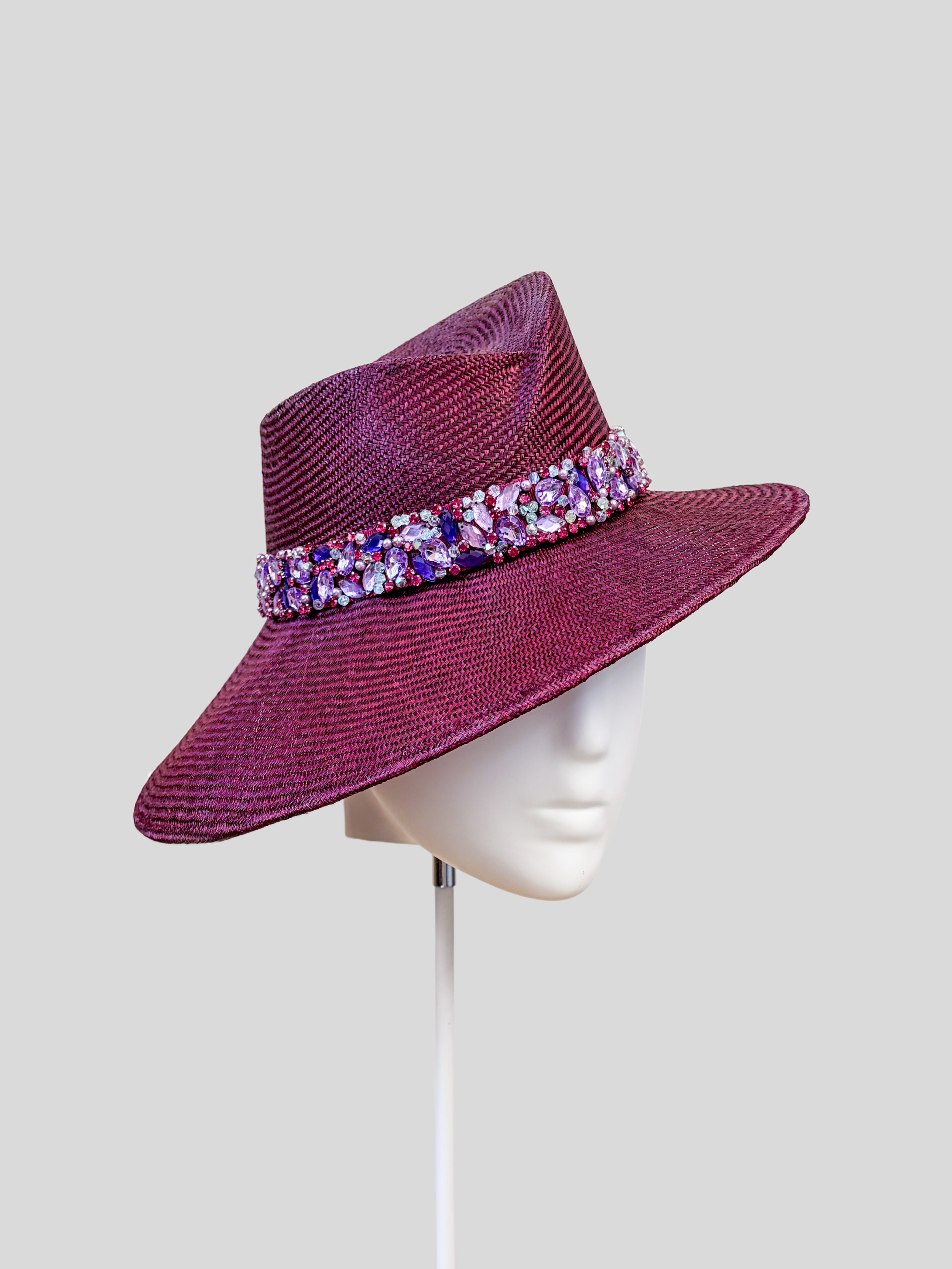 Left: Side view of the MAISON Amethyst Parisisal fedora showcasing its sculptural crown and hand-embellished band.