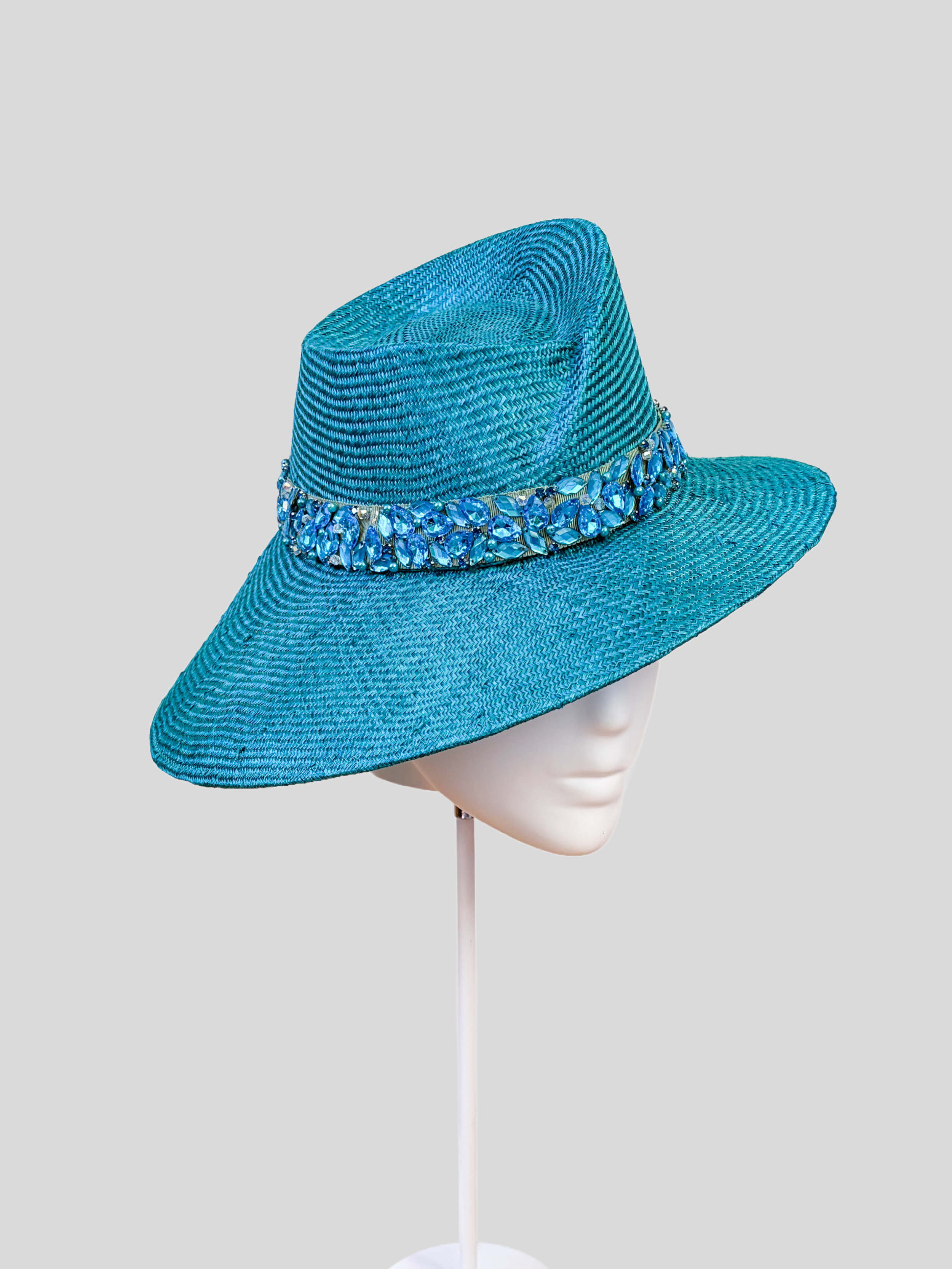 Left: Side view of the MAISON Azure Parisisal fedora showcasing its sculptural crown and hand-embellished band.