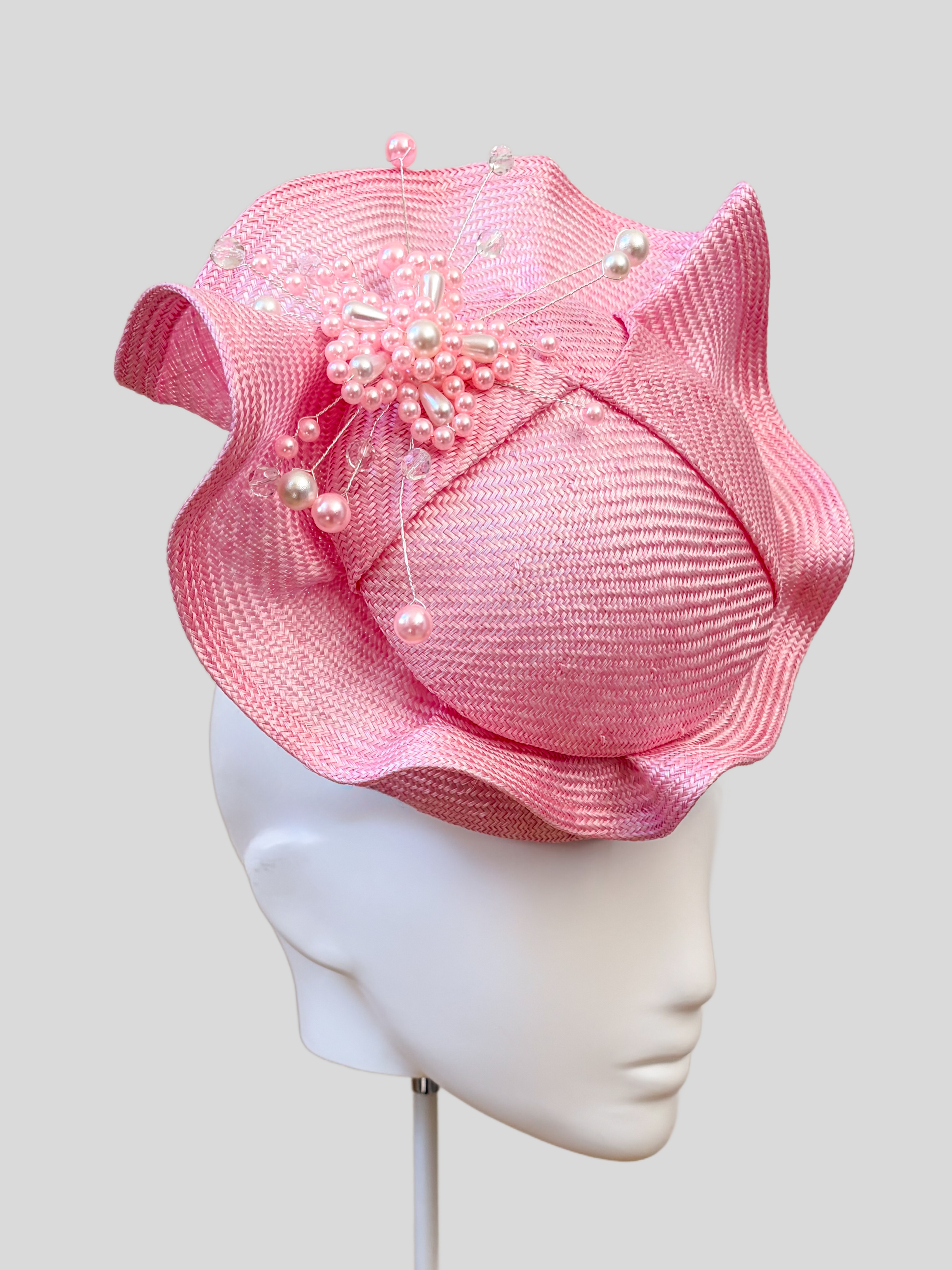 Close-up: Close-up of the hand-beaded rose-pink embellishment featuring tonal beads, pearls and crystal-style details.