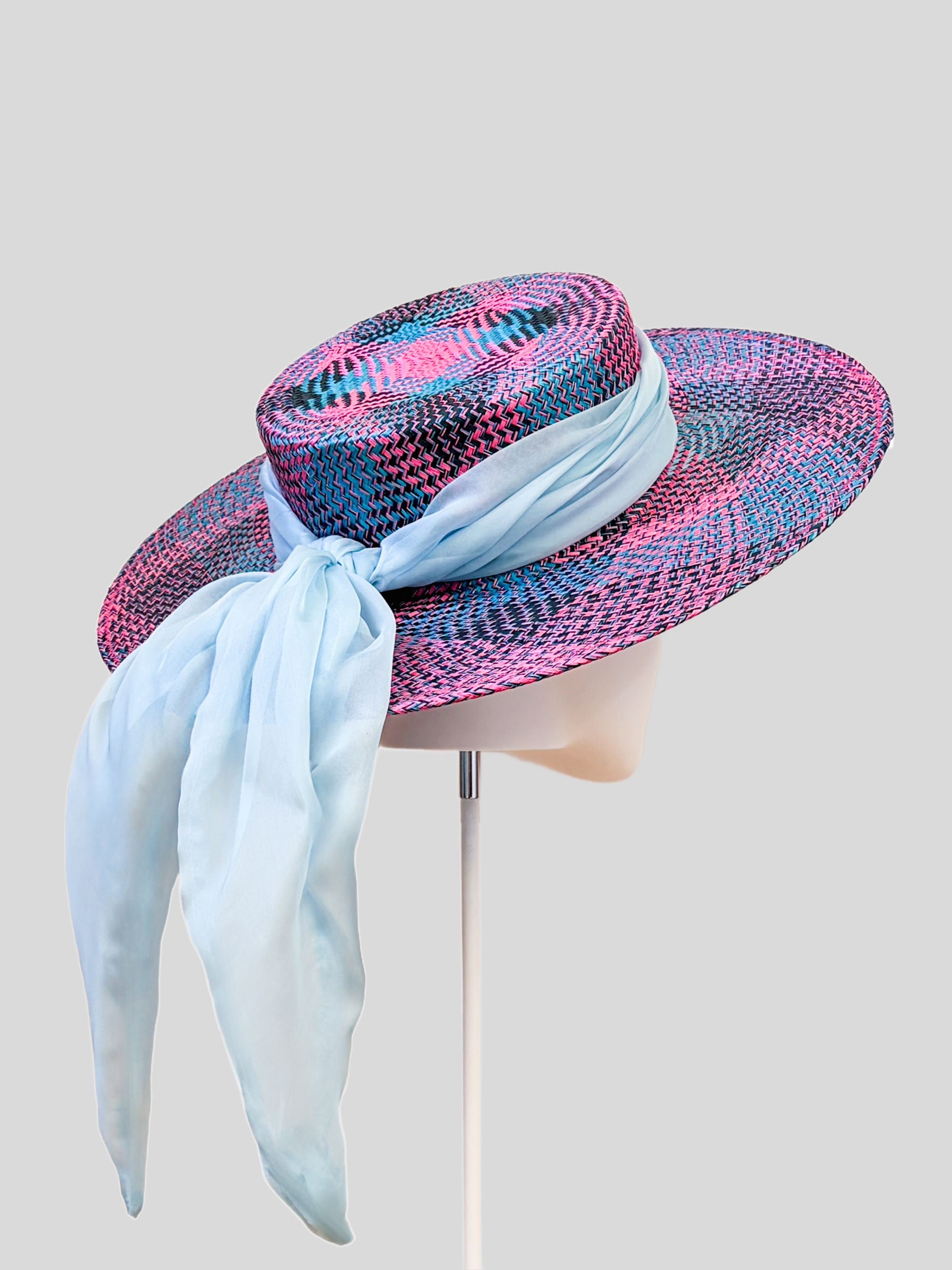 Solara Capri woven boater hat shown from the back with its flowing sky blue silk chiffon tie.