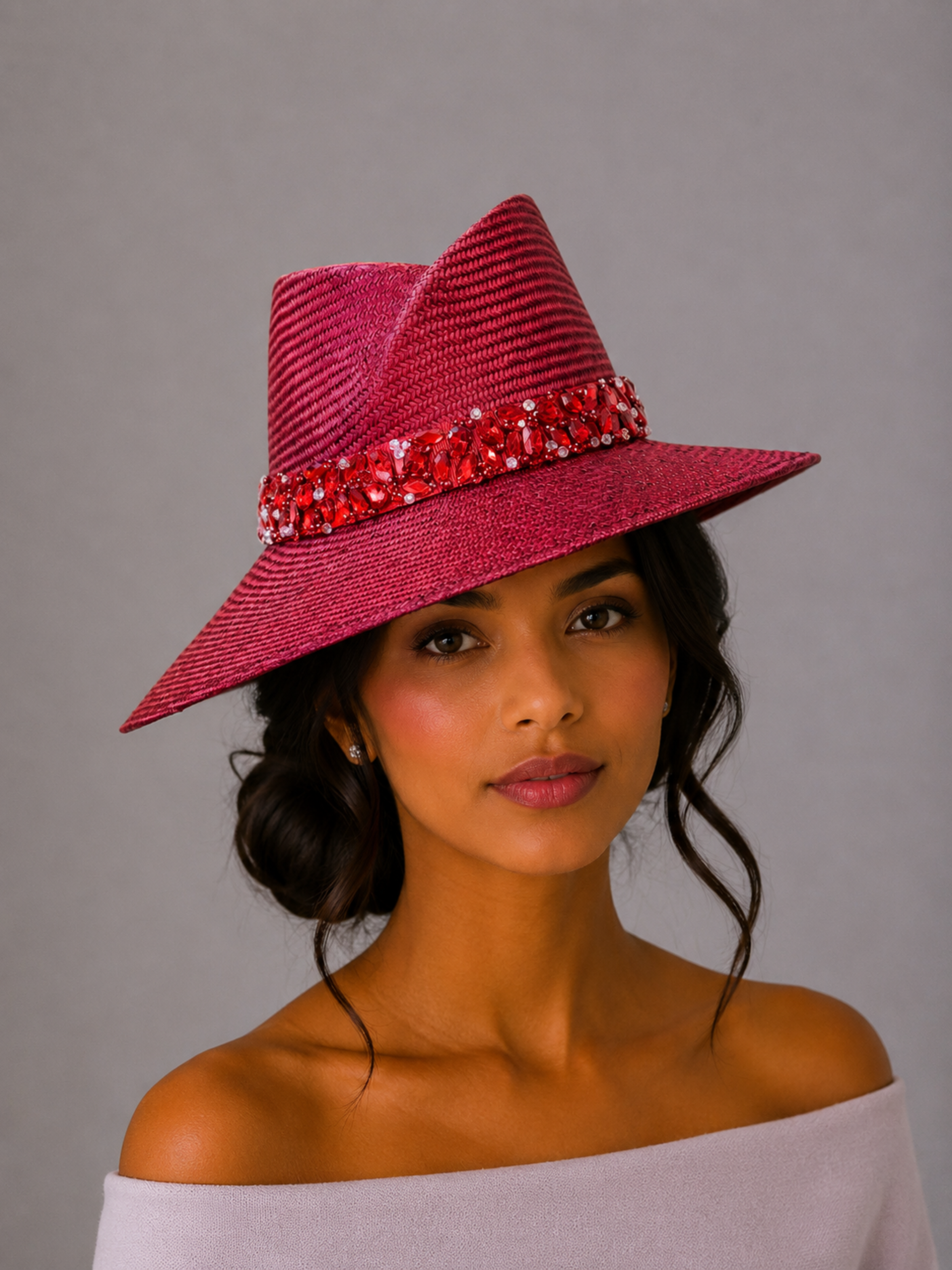 Model: MAISON Ruby Parisisal fedora styled on a model, showcasing the statement silhouette and hand-embellished red band.