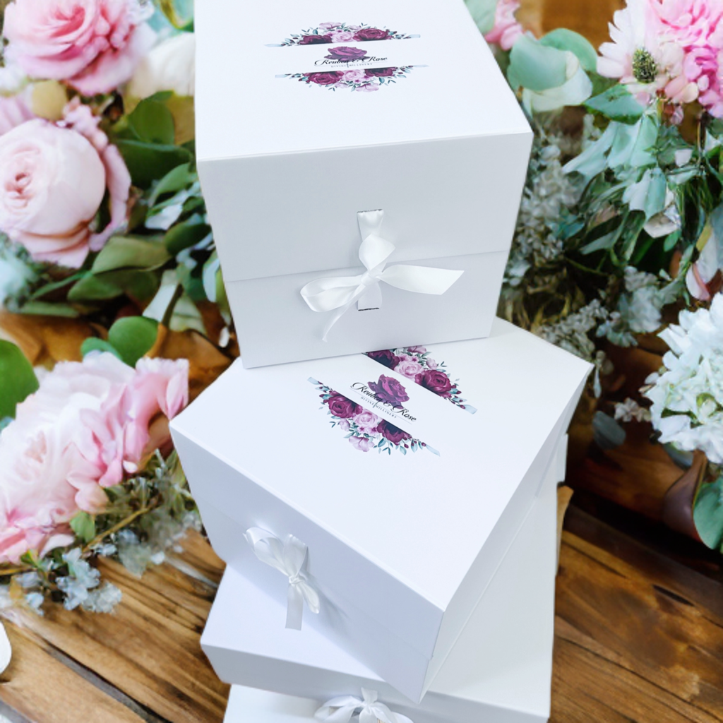 A selection of handcrafted hat boxes in various sizes and styles, designed for the safe and stylish storage of delicate millinery items.