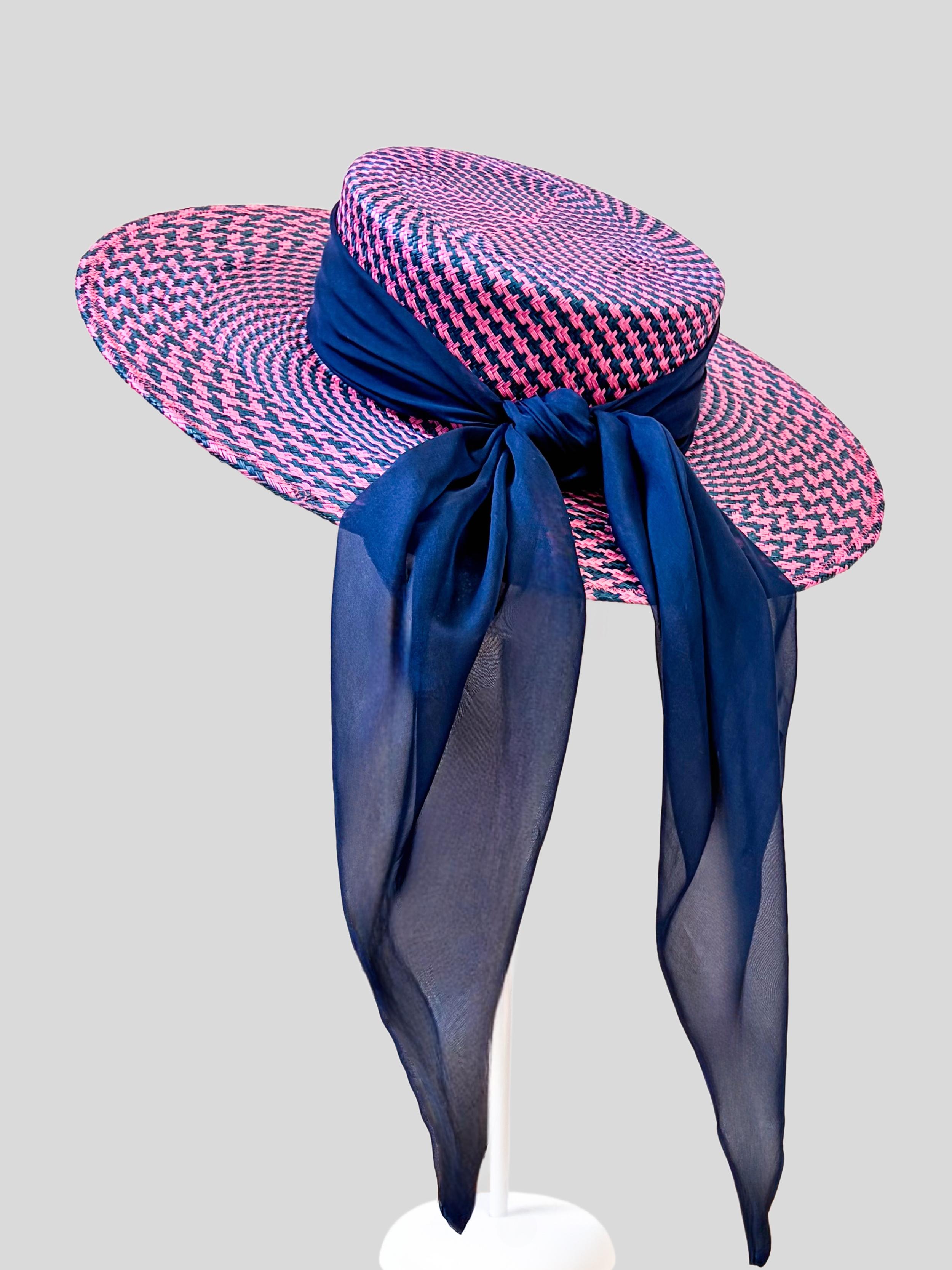Solara Cerise woven boater hat shown from the back with its flowing dark blue silk chiffon tie.