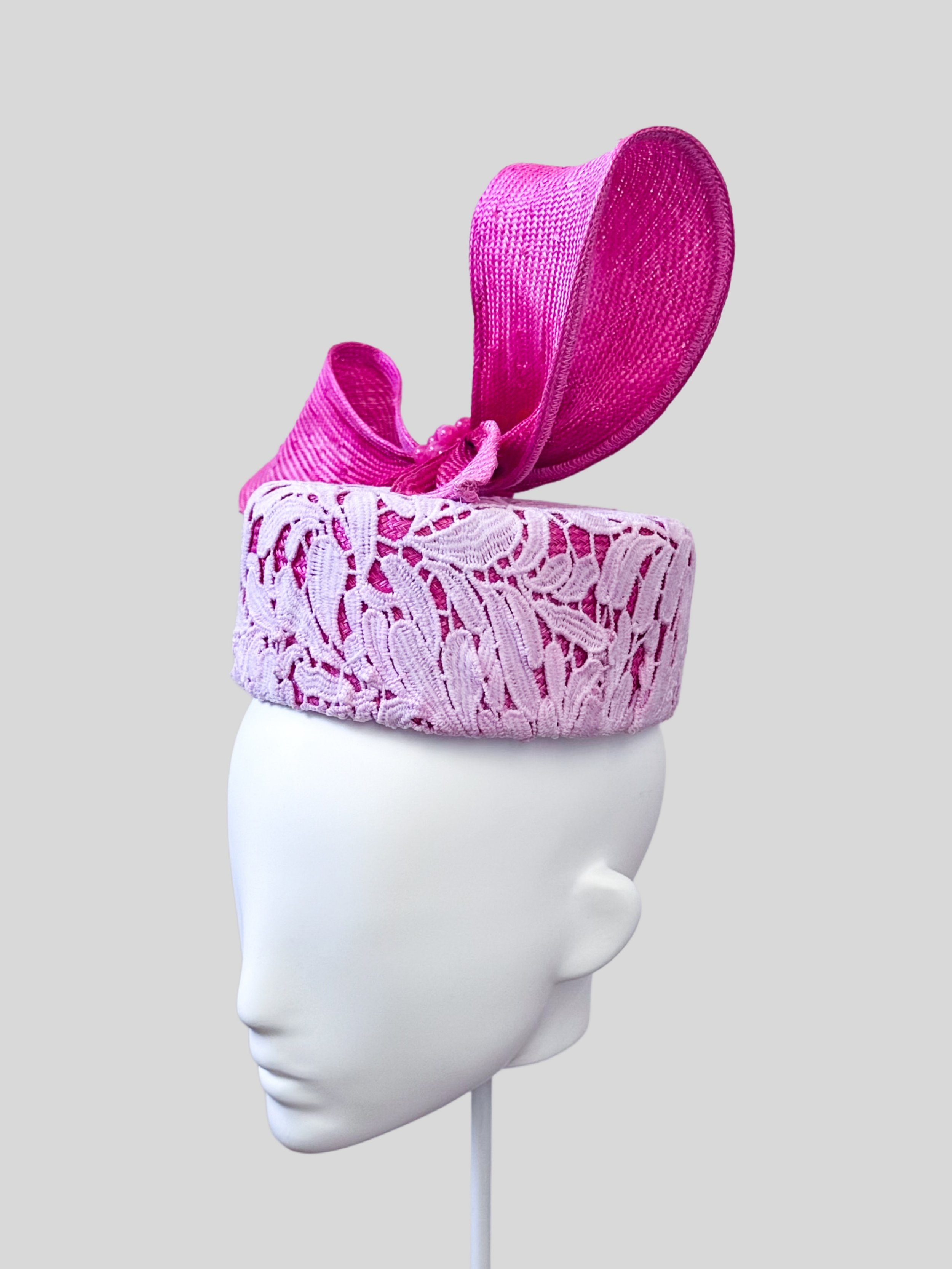 Right profile of the Ombre Lace Pillbox with Parisial Bow, illustrating the sleek lines and the striking ombre pink wired bow from this angle.