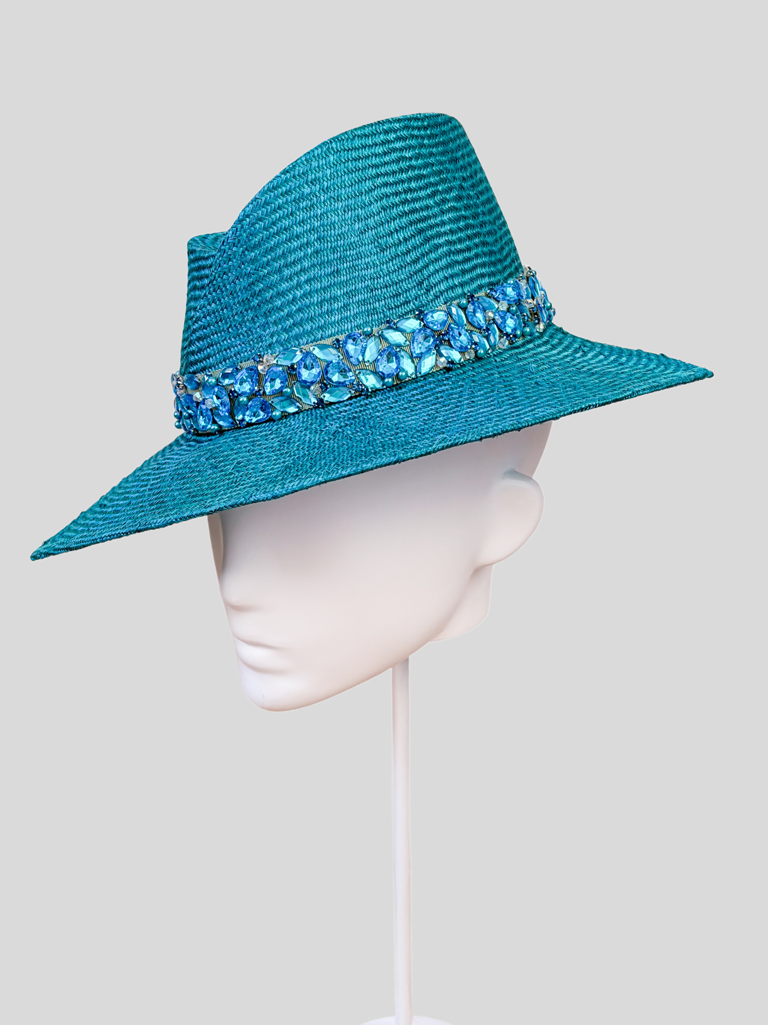 Right: Right-side view of the MAISON Azure Parisisal fedora highlighting its vibrant azure finish and tonal embellishment.