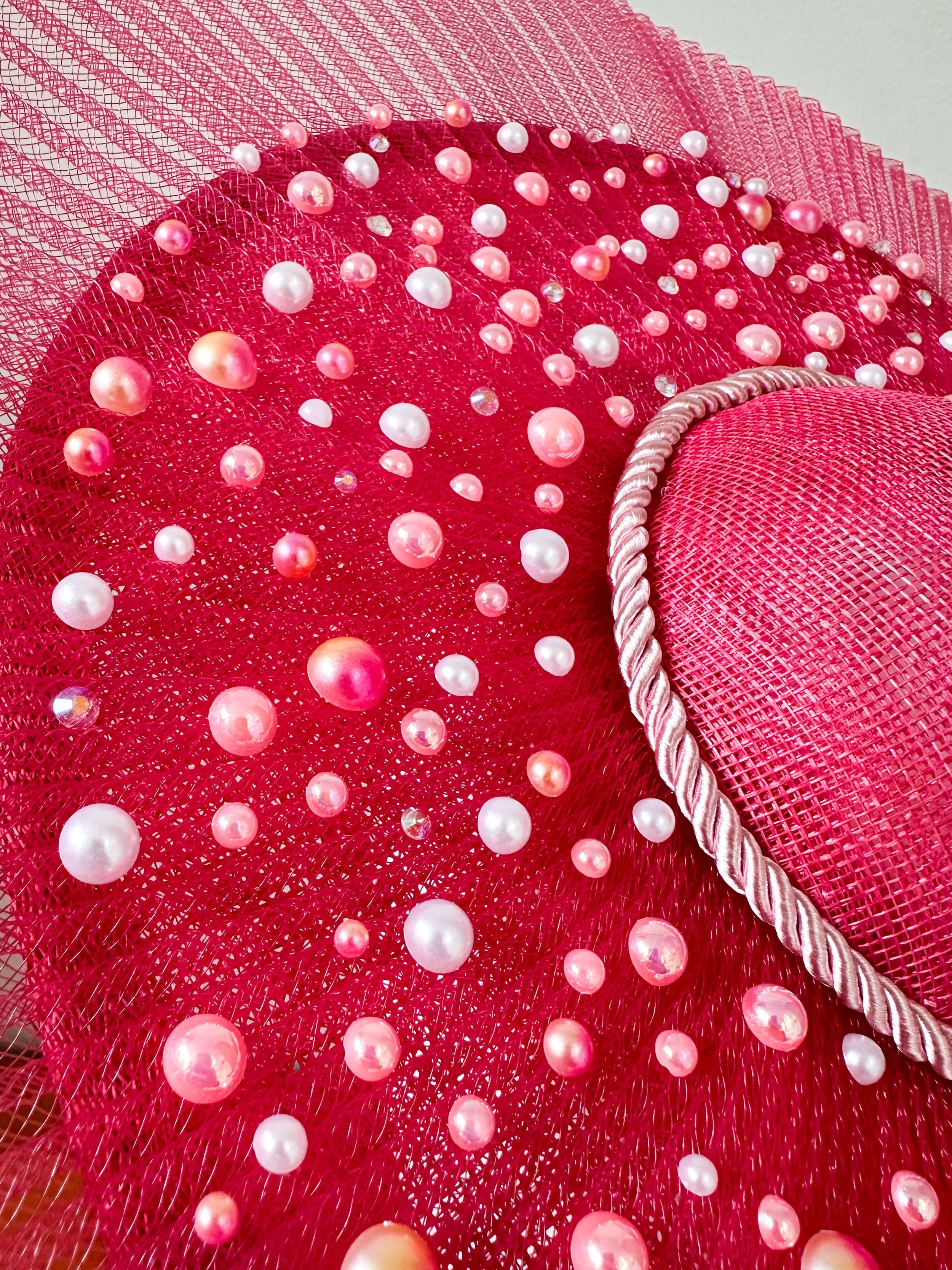 A detailed close-up of the Perles Roses hat, showing the intricate handbeaded cabochon pearls and delicate crinoline texture. Handmade in Melbourne, Australia.