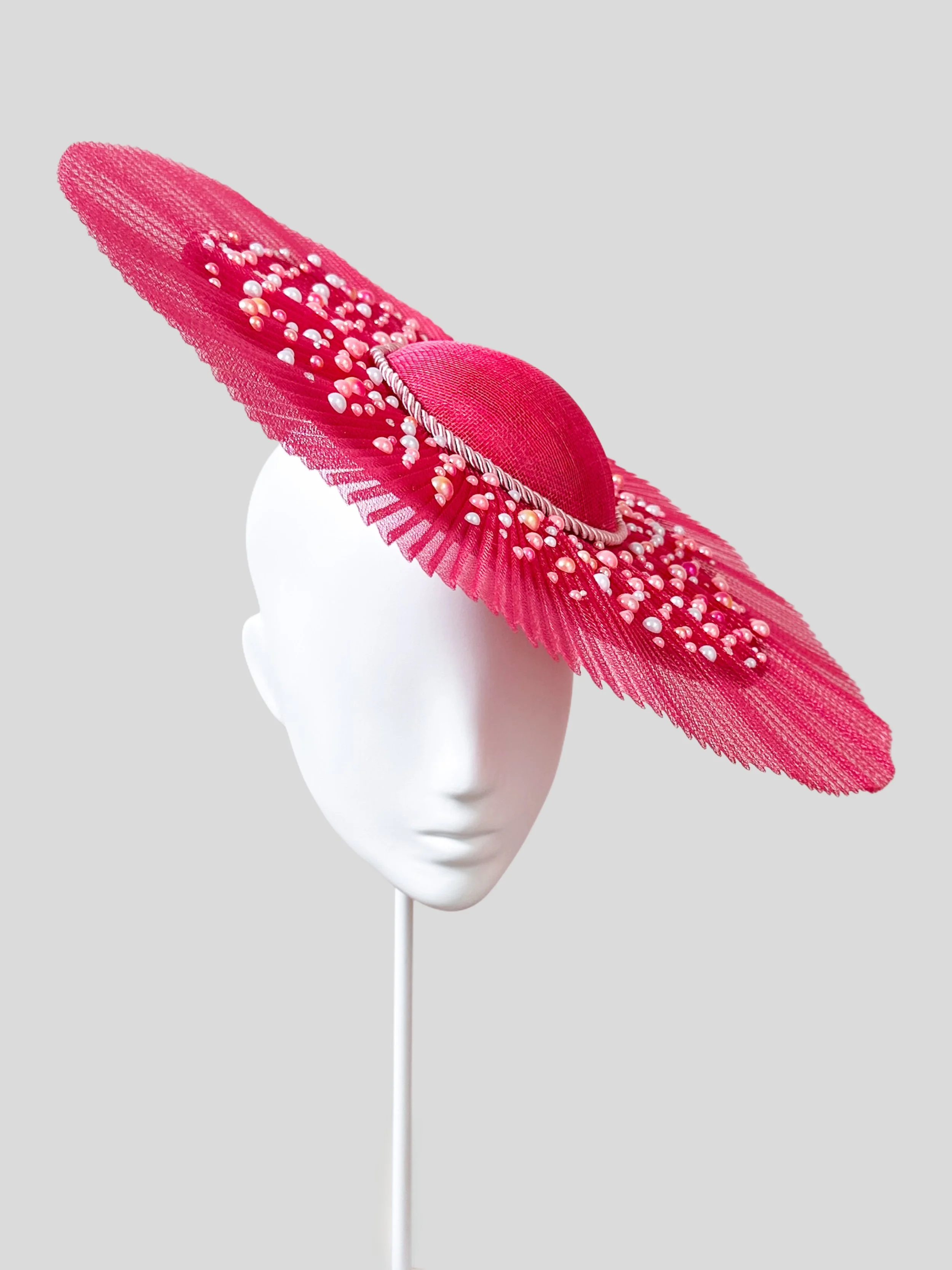 View of the Perles Roses hat from the left side, showcasing how the headpiece is worn at a chic angle. Handmade with attention to detail.