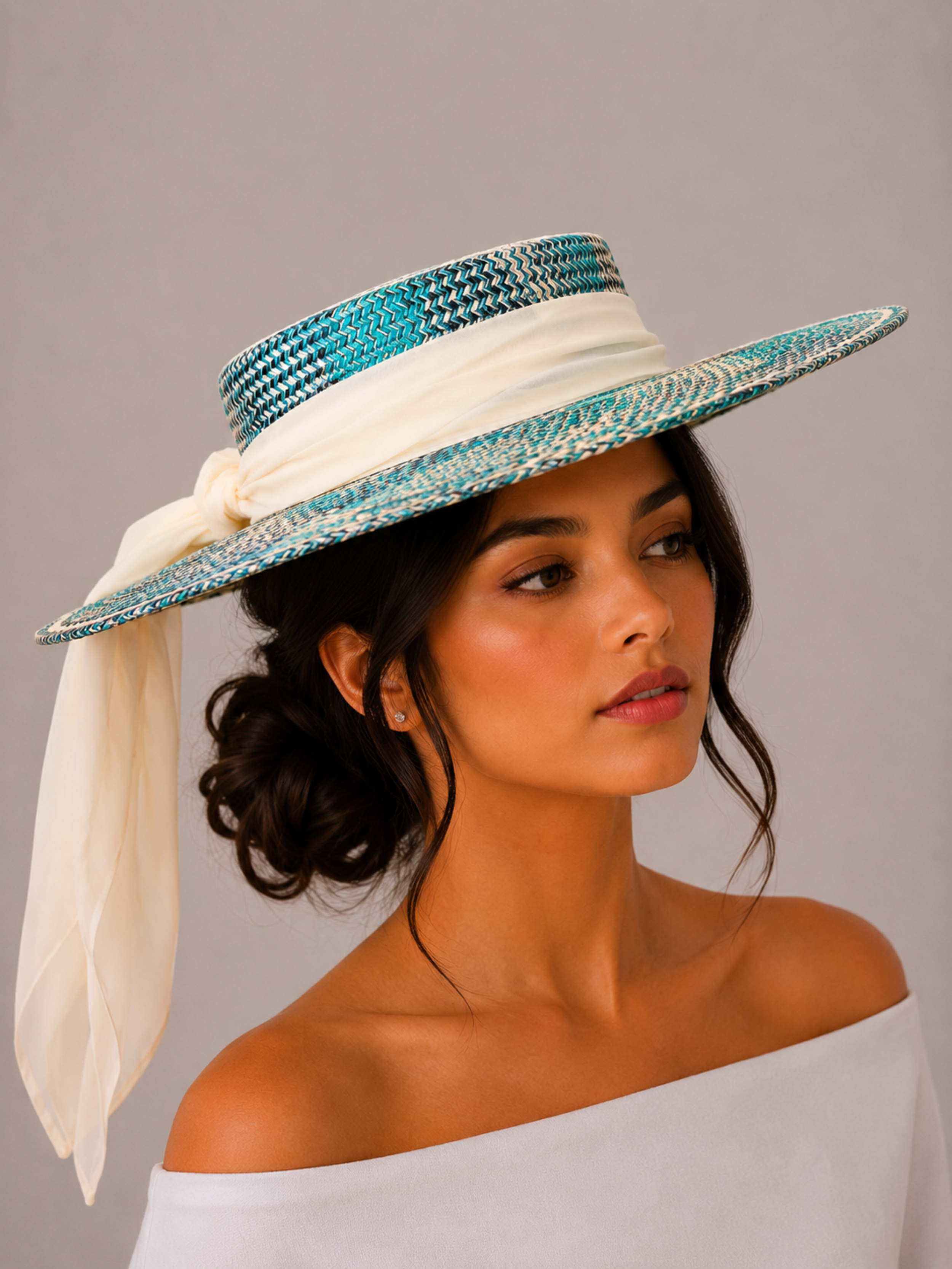 Solara Azure woven boater hat styled on a model with a flowing apricot silk chiffon tie.