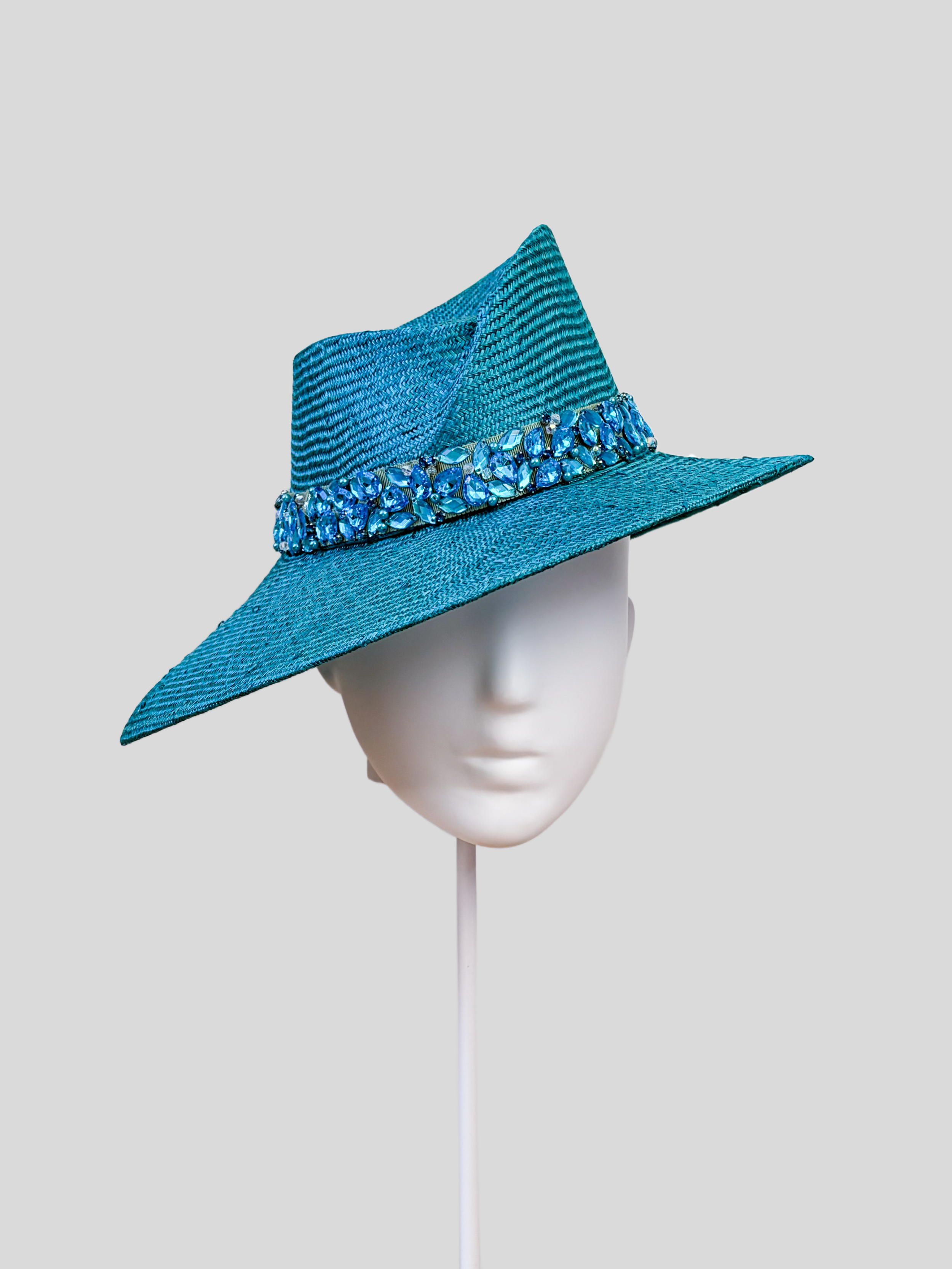 Front: MAISON Azure Parisisal fedora featuring a sculptural Divine Millinery block and hand-embellished blue beaded band.