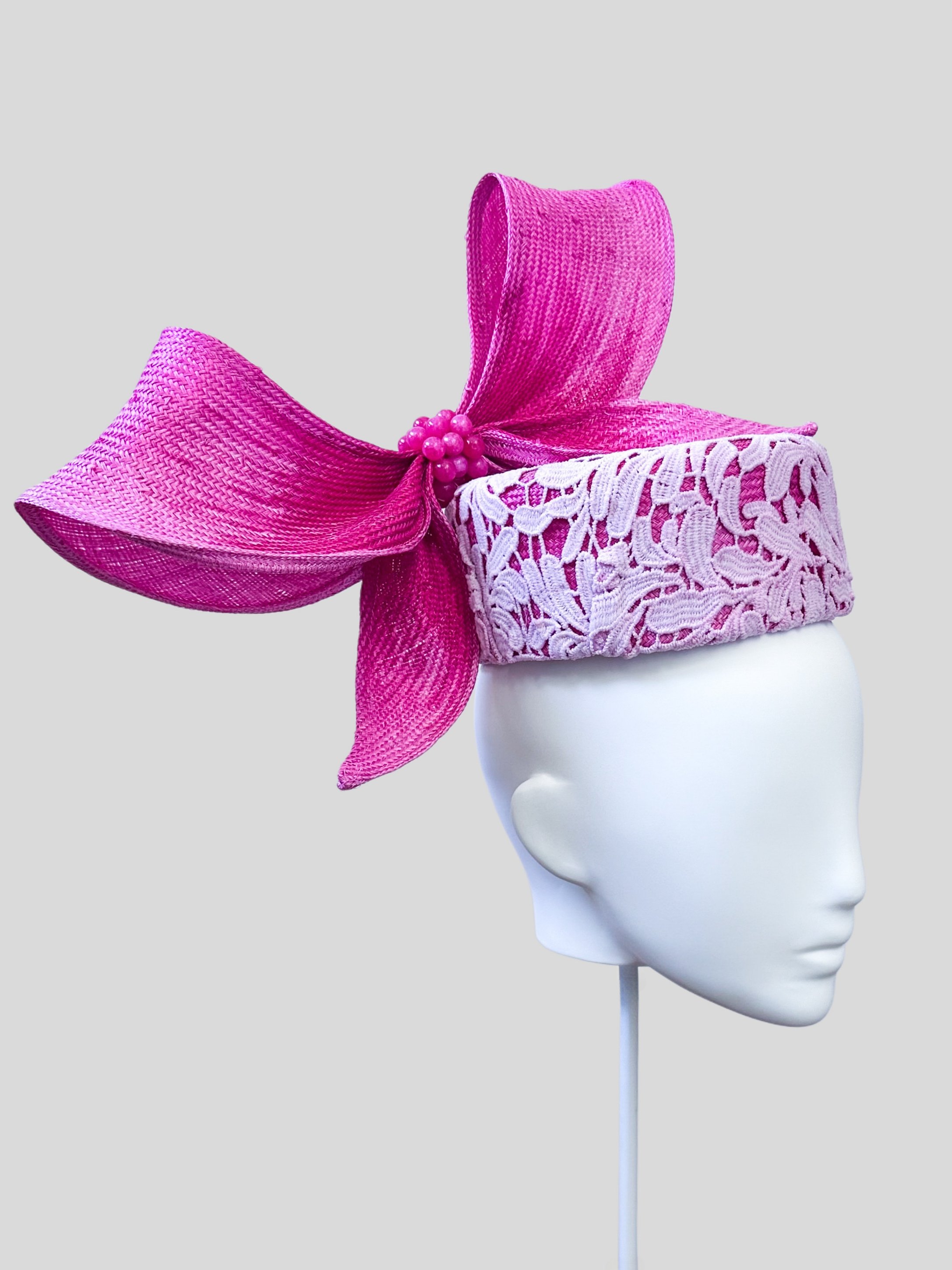 Left profile of the Ombre Lace Pillbox with Parisial Bow, revealing the elegant curvature and the beautifully designed ombre pink wired bow.