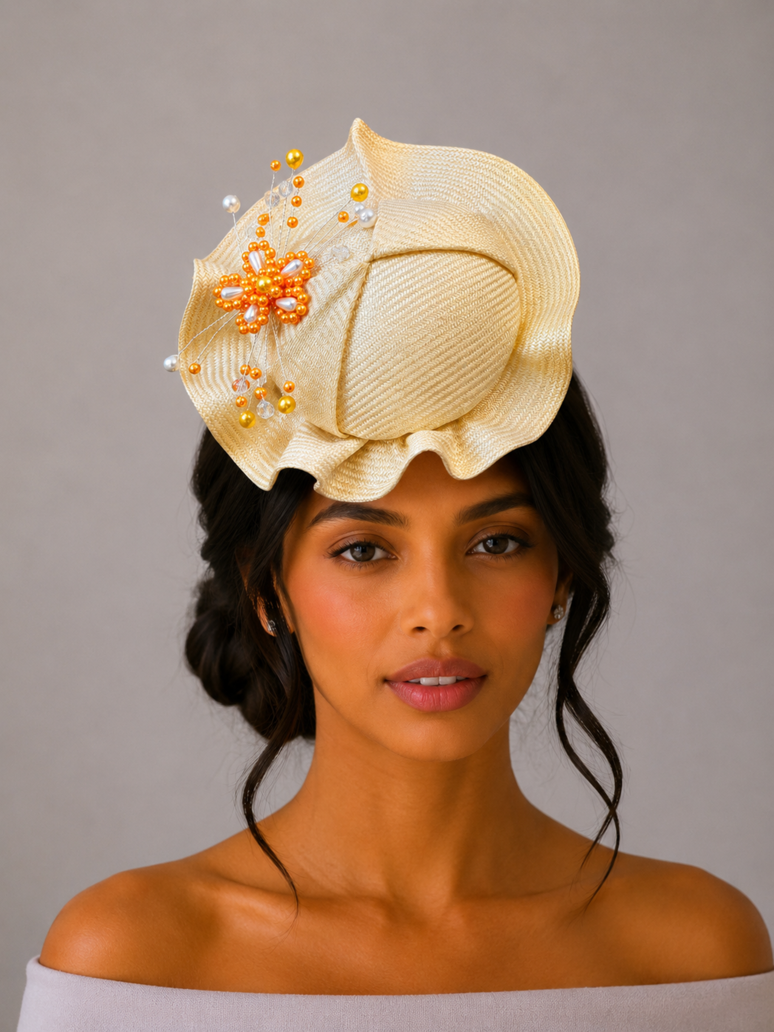 Model: VÉRA Citrine Parisisal cocktail hat styled on a model, showcasing its sculptural silhouette and intricate hand-beaded embellishment.