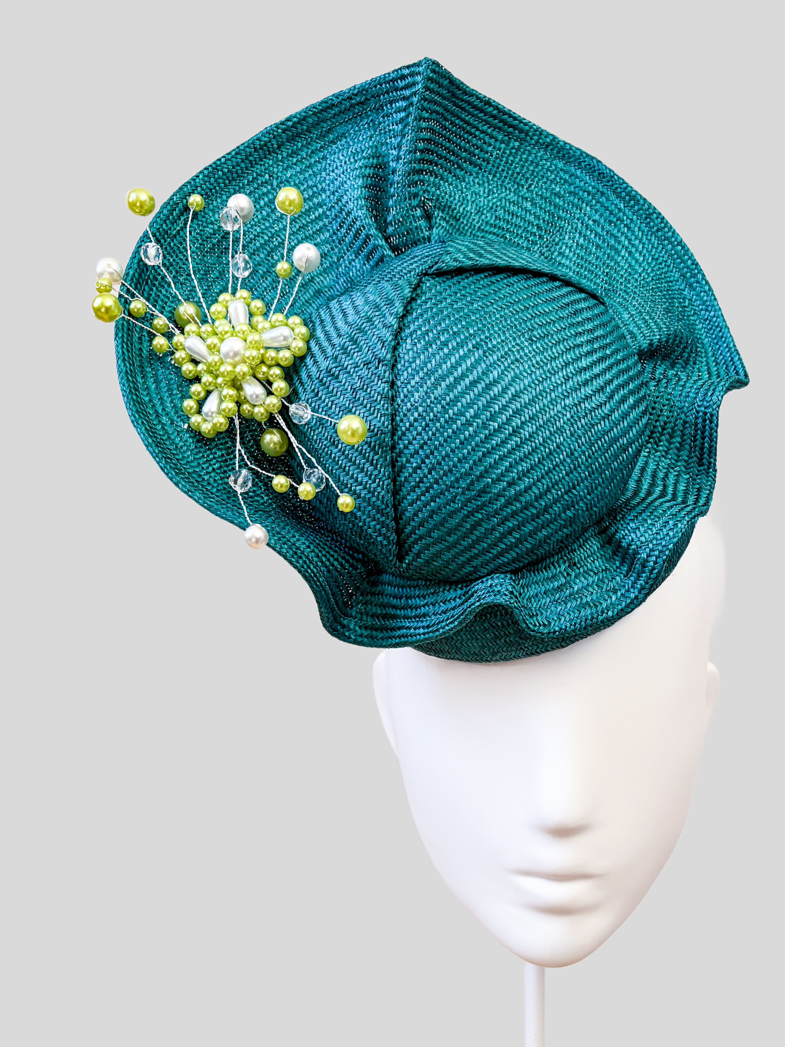 Close-up: Close-up of the hand-beaded teal embellishment featuring tonal beads, lime-green accents, pearls and crystal-style details.
