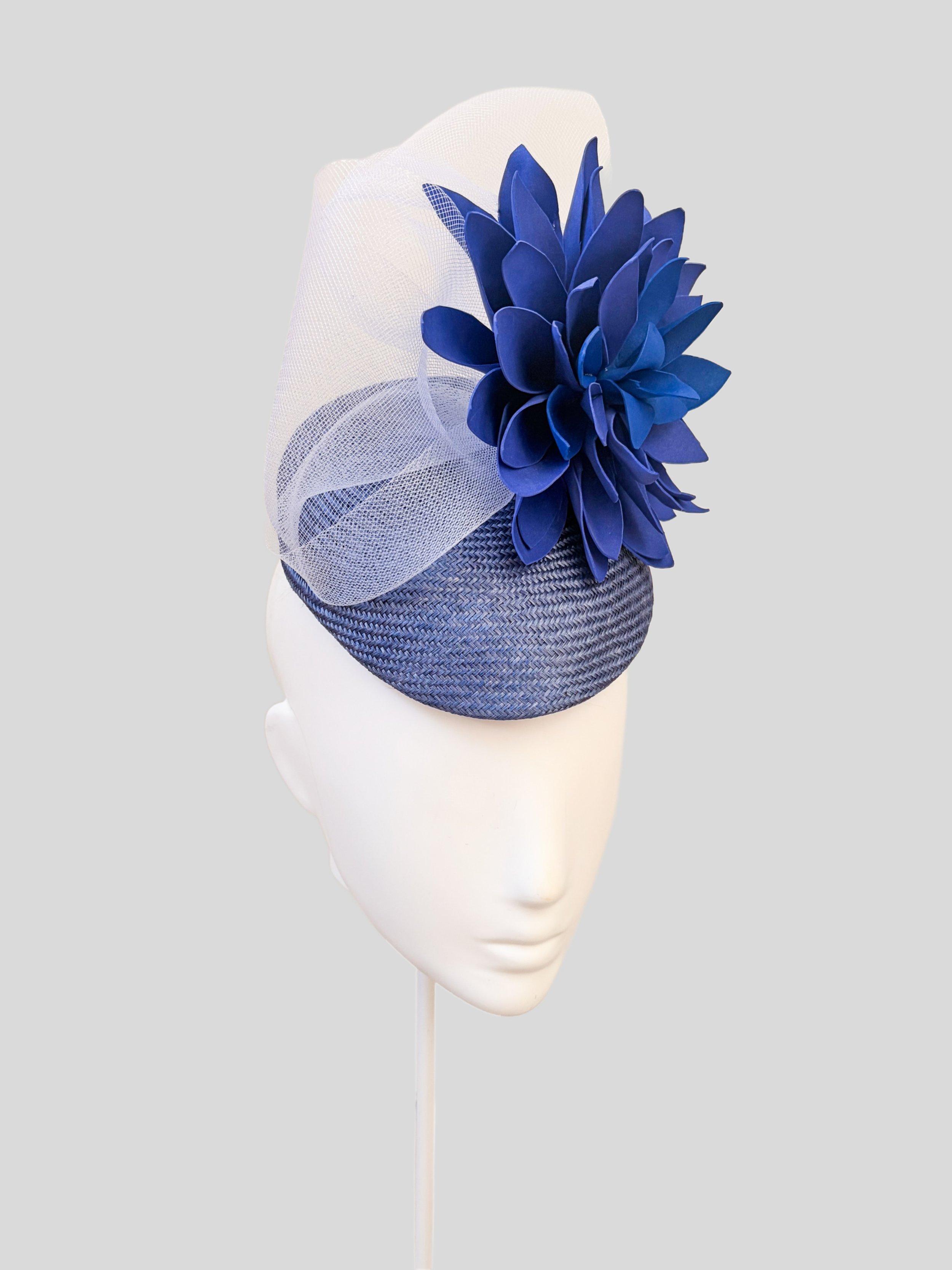 Side view of the PETALIA Blue floral headpiece, showcasing its layered flower and elegant silhouette.