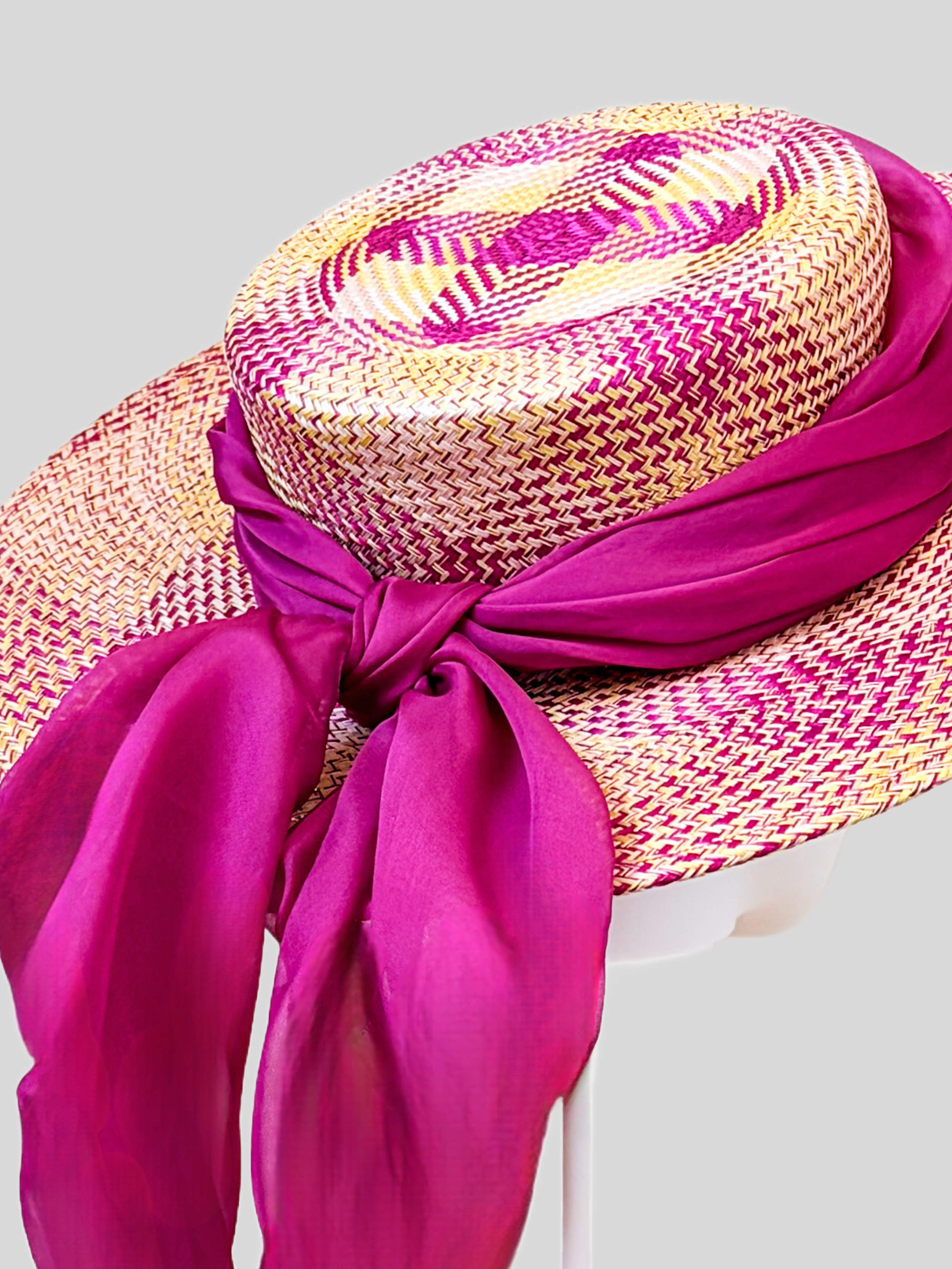 Close-up of Solara Fuchsia woven buntal texture and rose-purple silk chiffon detailing.