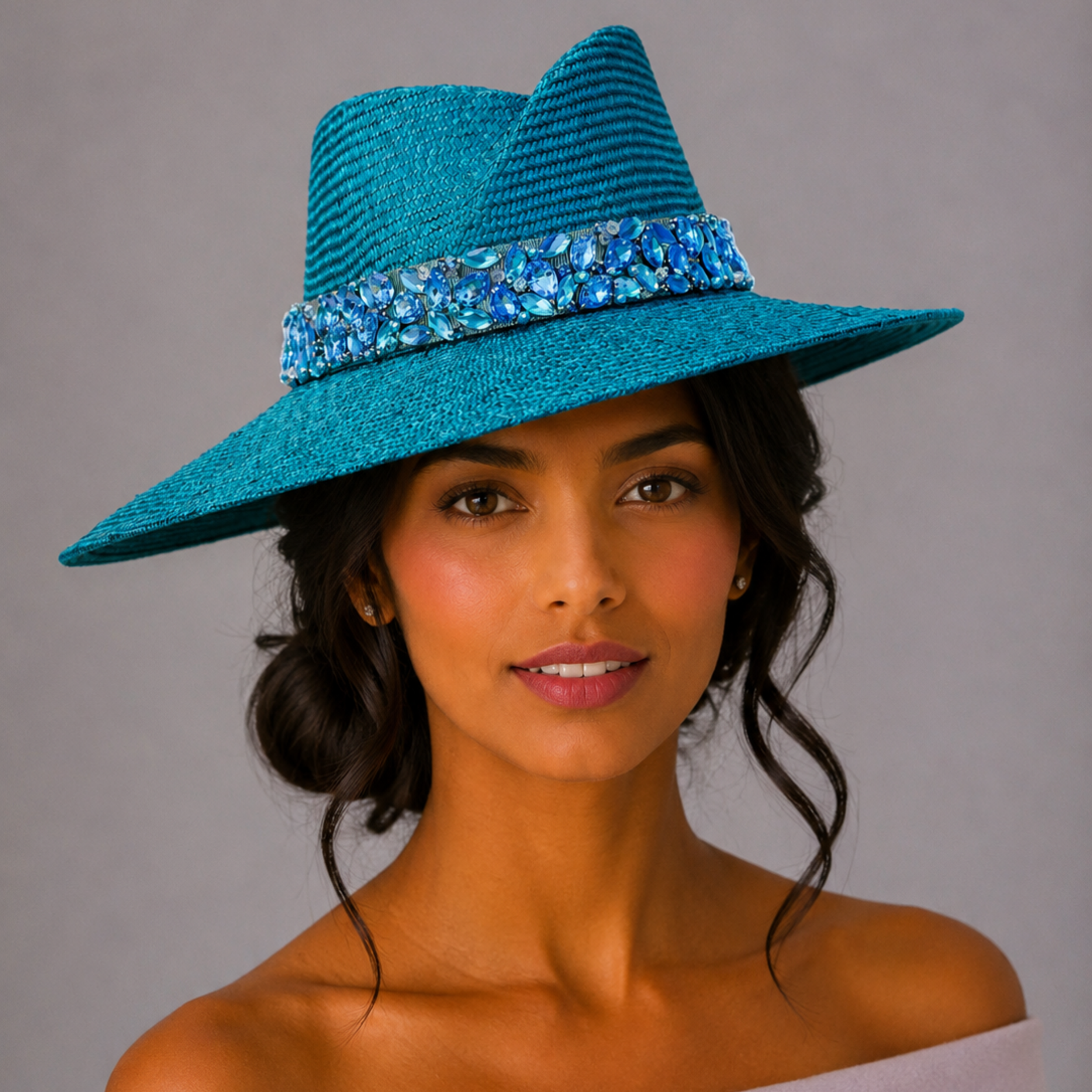 Model: MAISON Azure Parisisal fedora styled on a model, showcasing the statement silhouette and hand-embellished blue band.