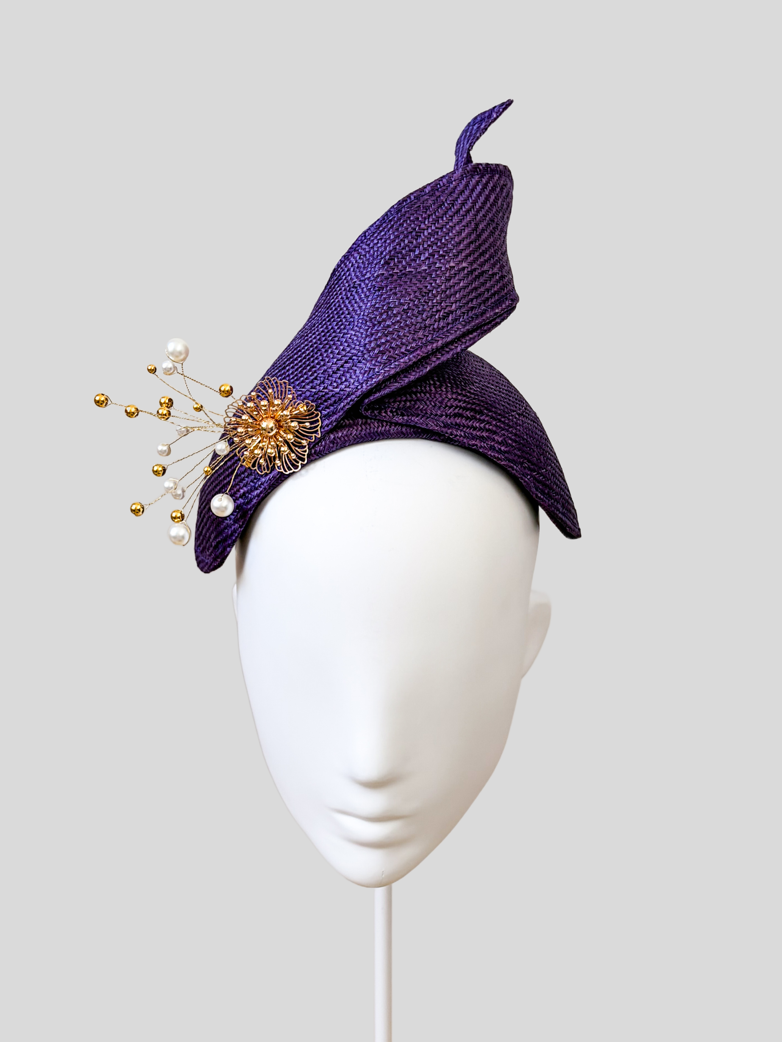 Front: SÉLÈNE Amethyst Parisisal bandeau headband featuring sculptural twisted straw detailing and gold embellishment.