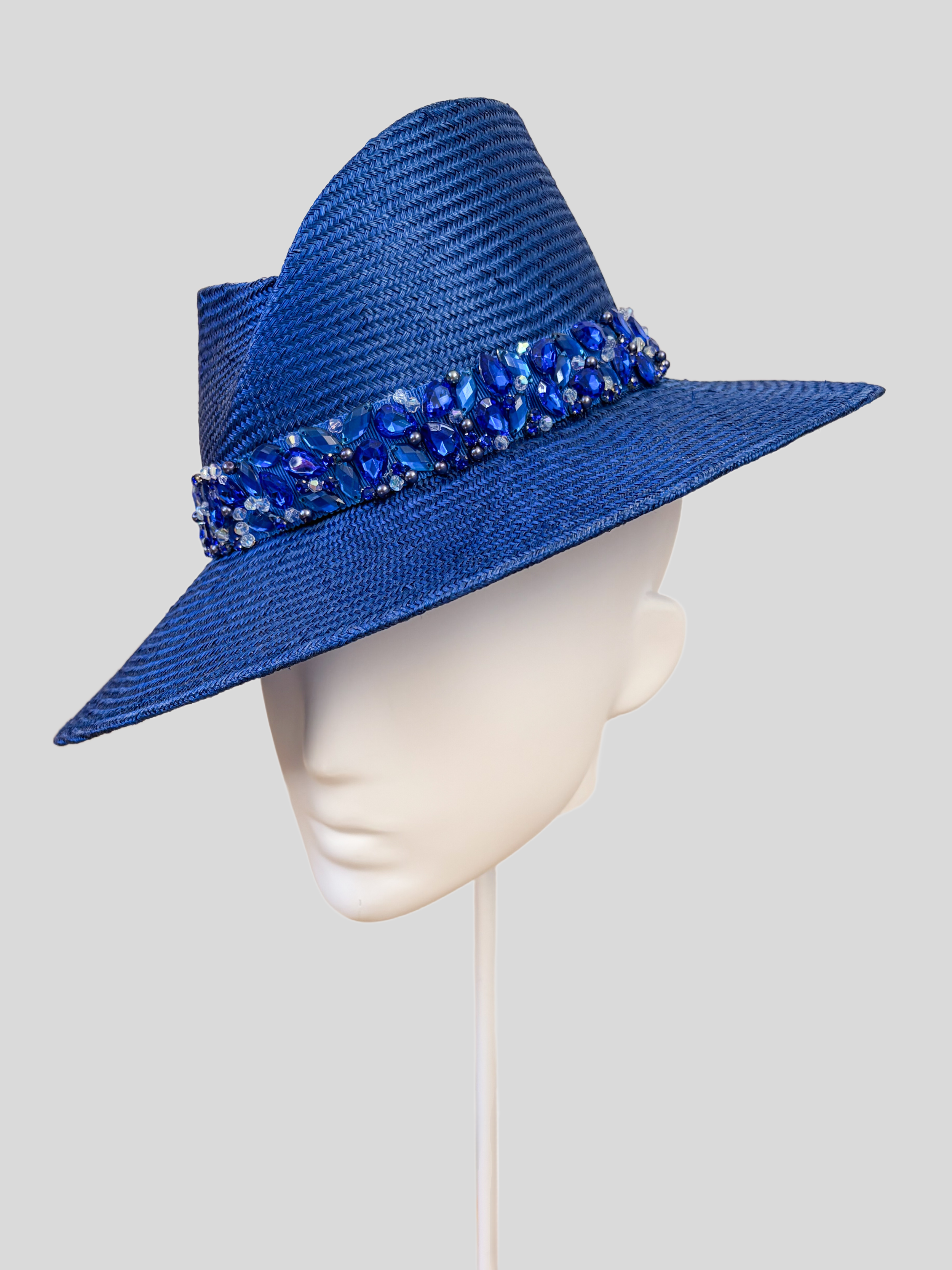 Right: Right-side view of the MAISON Sapphire Parisisal fedora highlighting its rich sapphire-blue finish and tonal embellishment.