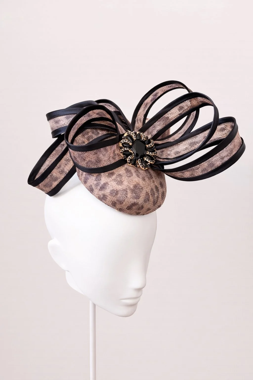 Elegant snakeskin-inspired fascinator with gems.JPEG