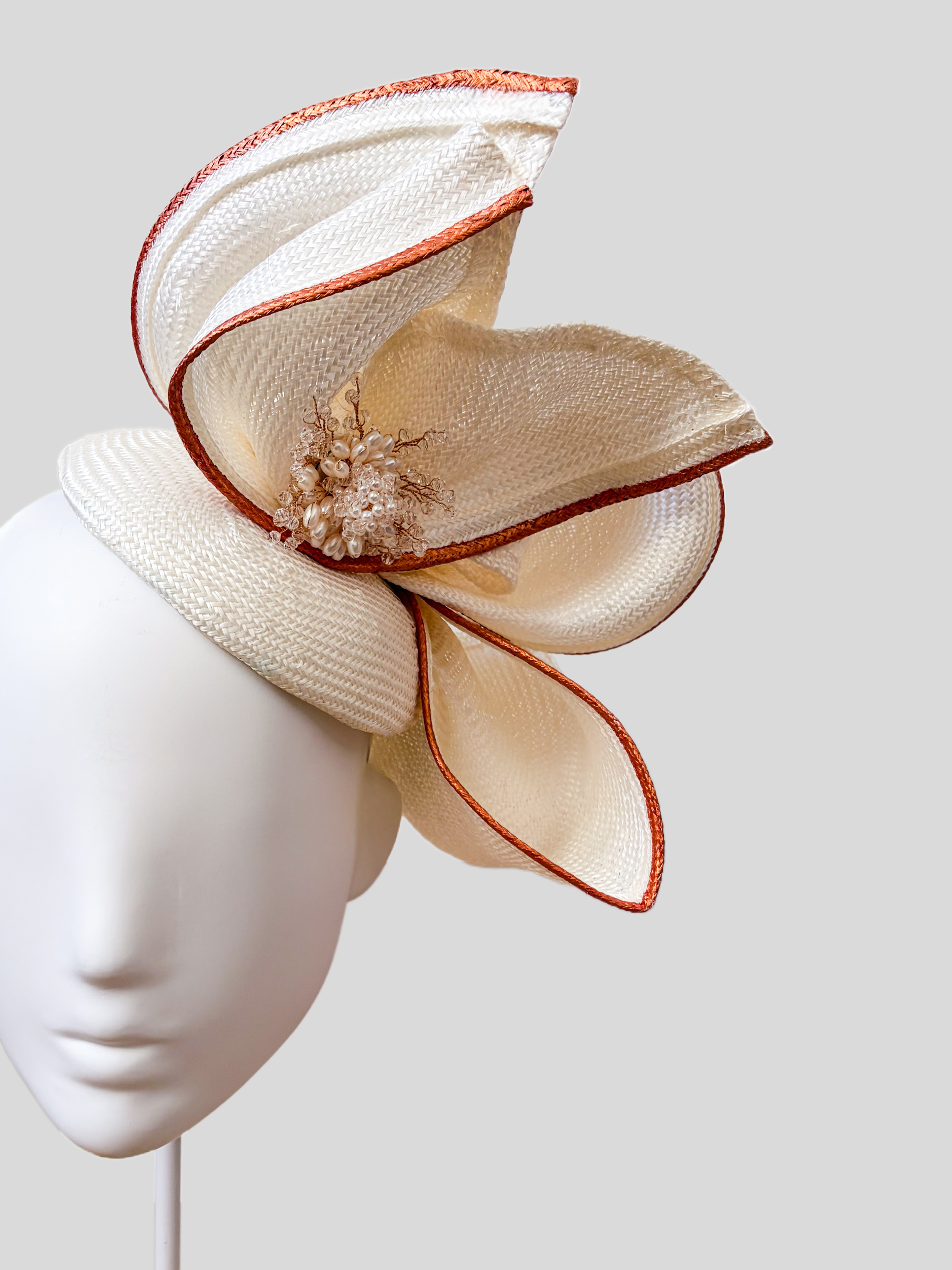 Close-up of Aria Ivory Parisisal straw, rose-gold edging and pearl and crystal detailing.