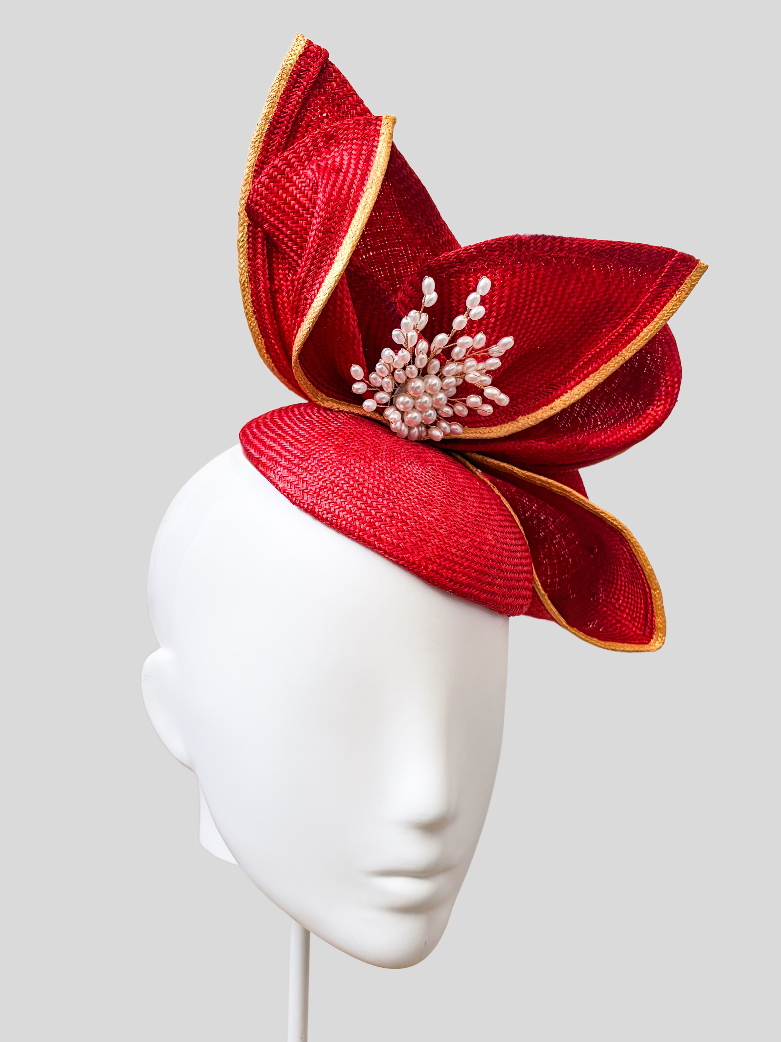 Aria Ruby sculptural headpiece shown from the left side.