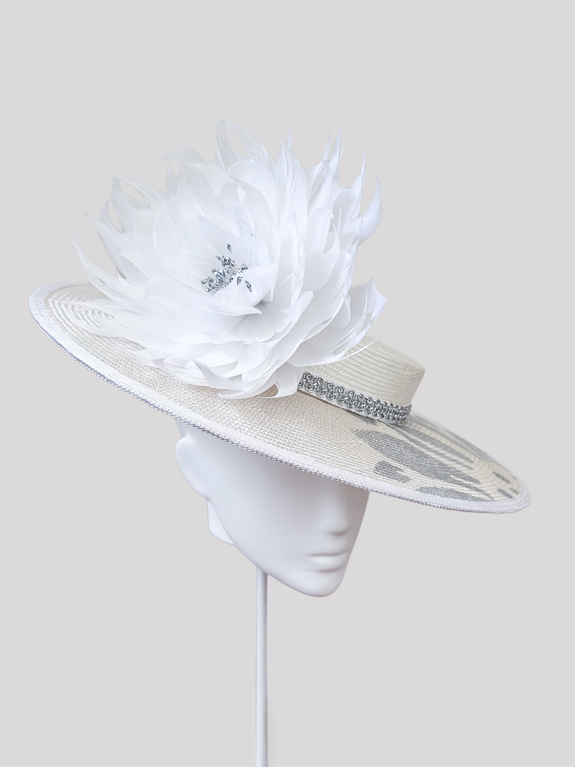 Blancura boater hat: Left view showcasing its unique profile and delicate white feather accent. Handcrafted parisisal hat, made in Melbourne.