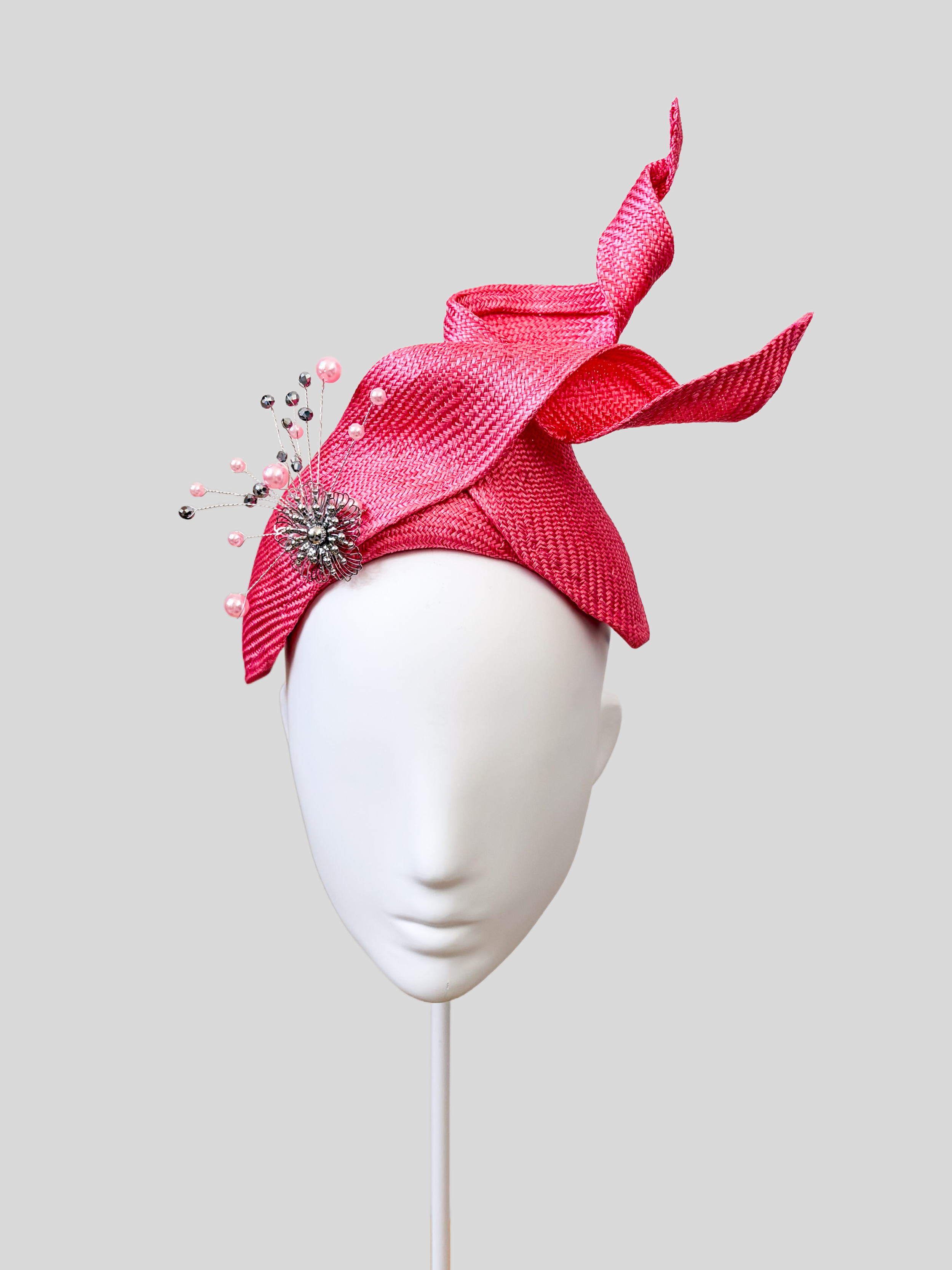 Front: SÉLÈNE Rose Parisisal bandeau headband featuring sculptural twisted straw detailing and silver embellishment.