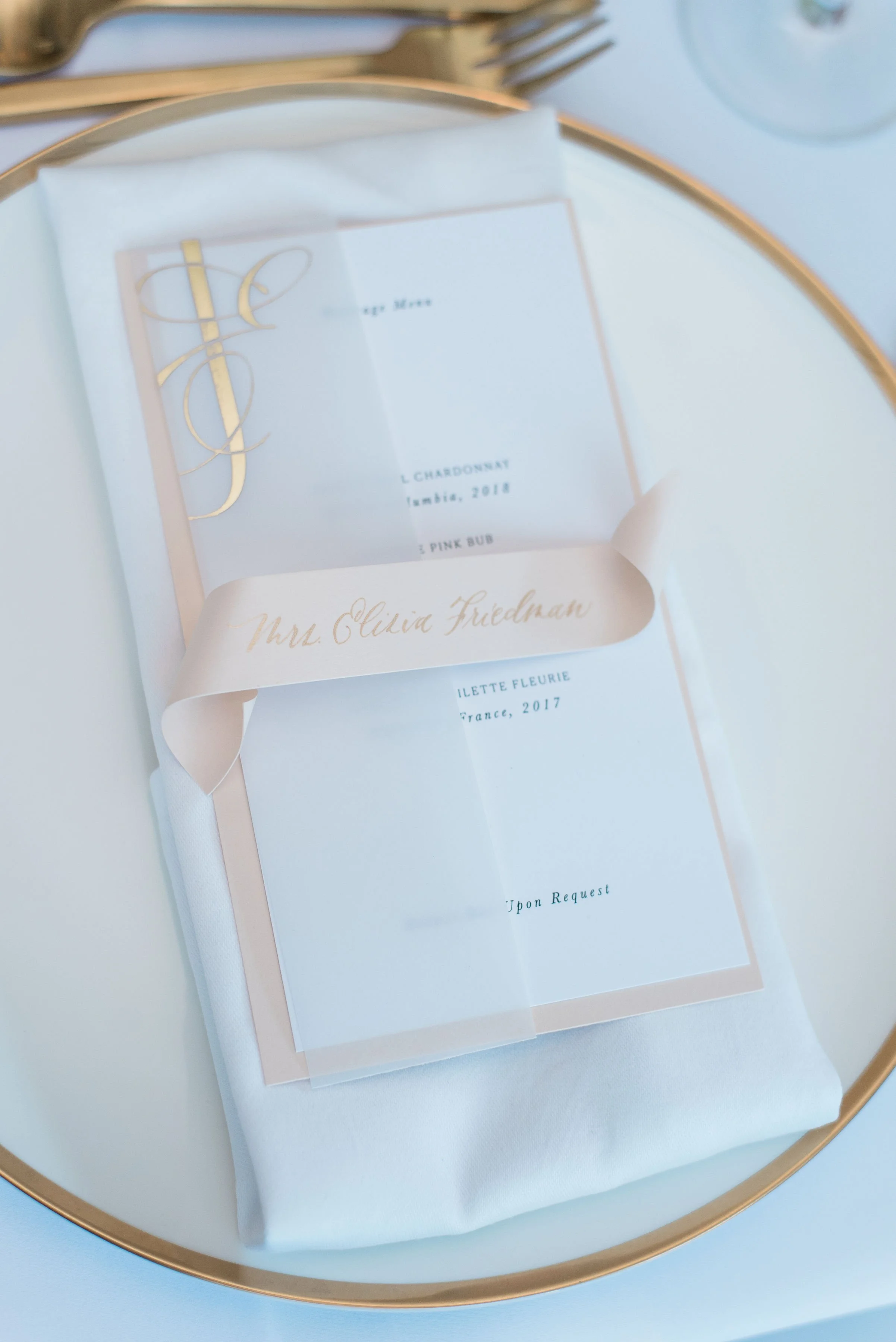 Wedding dinner and beverage menu with scroll placecard with guestname in gold calligraphy.