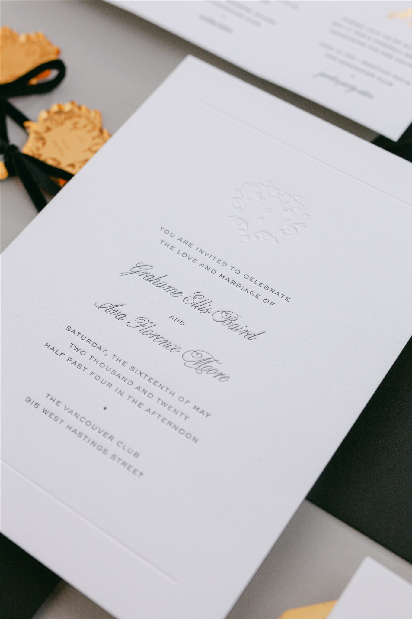 Custom monogram invitation card in black and blind letterpress.