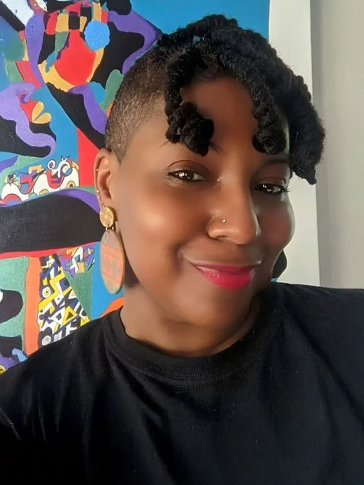 Person smiling, wearing a black shirt