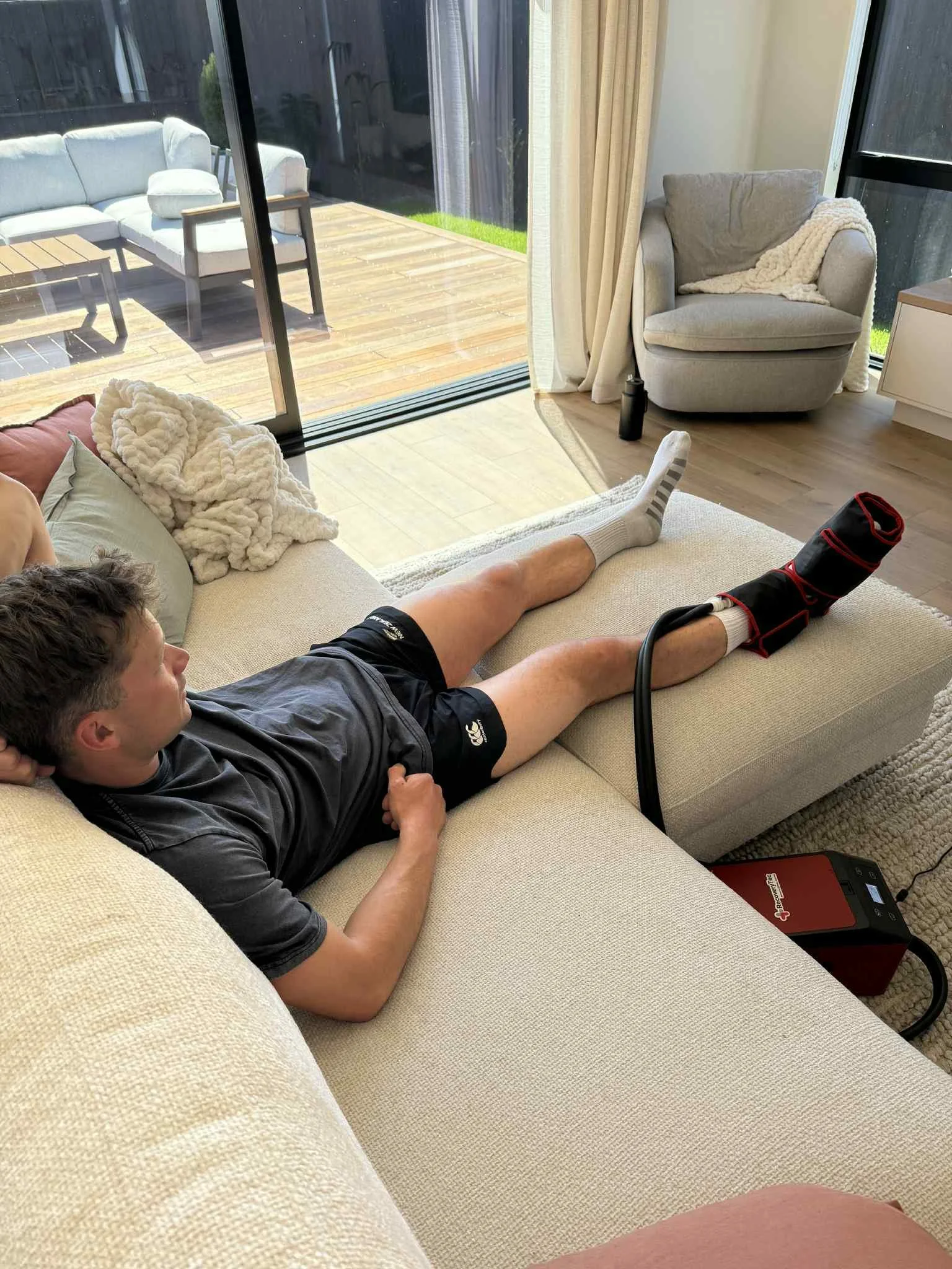 CryoPush ice compression machine on ankle during post-surgery recovery — cold compression therapy hire available in Christchurch and NZ